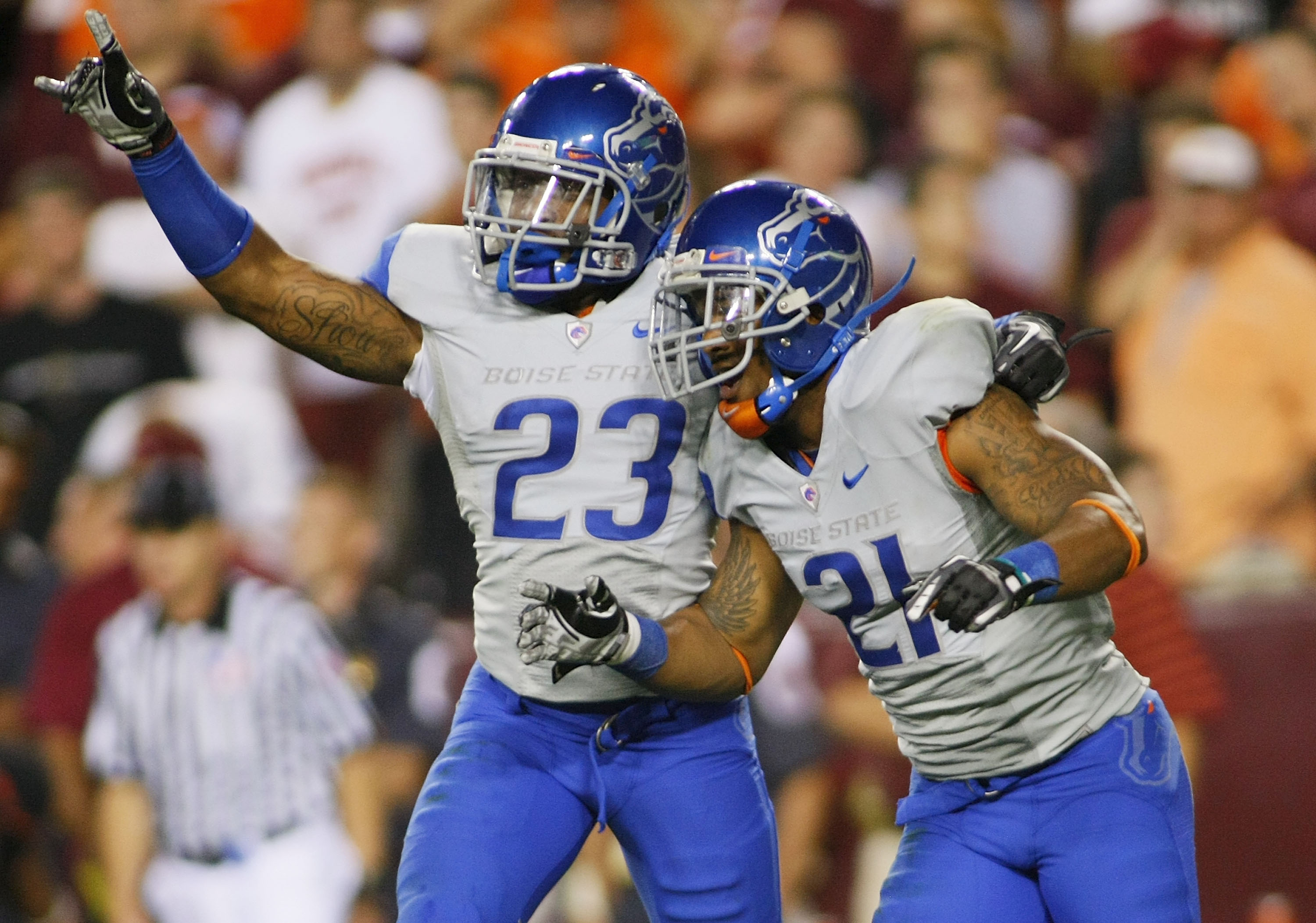 LANDOVER, MD - SEPTEMBER 06:  Safety #23 Jeron Johnson of and cornerback #21 Jamar Taylor of the Boise State Broncos celebrate defeating the Virginia Tech Hokies 33-30 at FedExField on September 6, 2010 in Landover, Maryland.  (Photo by Geoff Burke/Getty