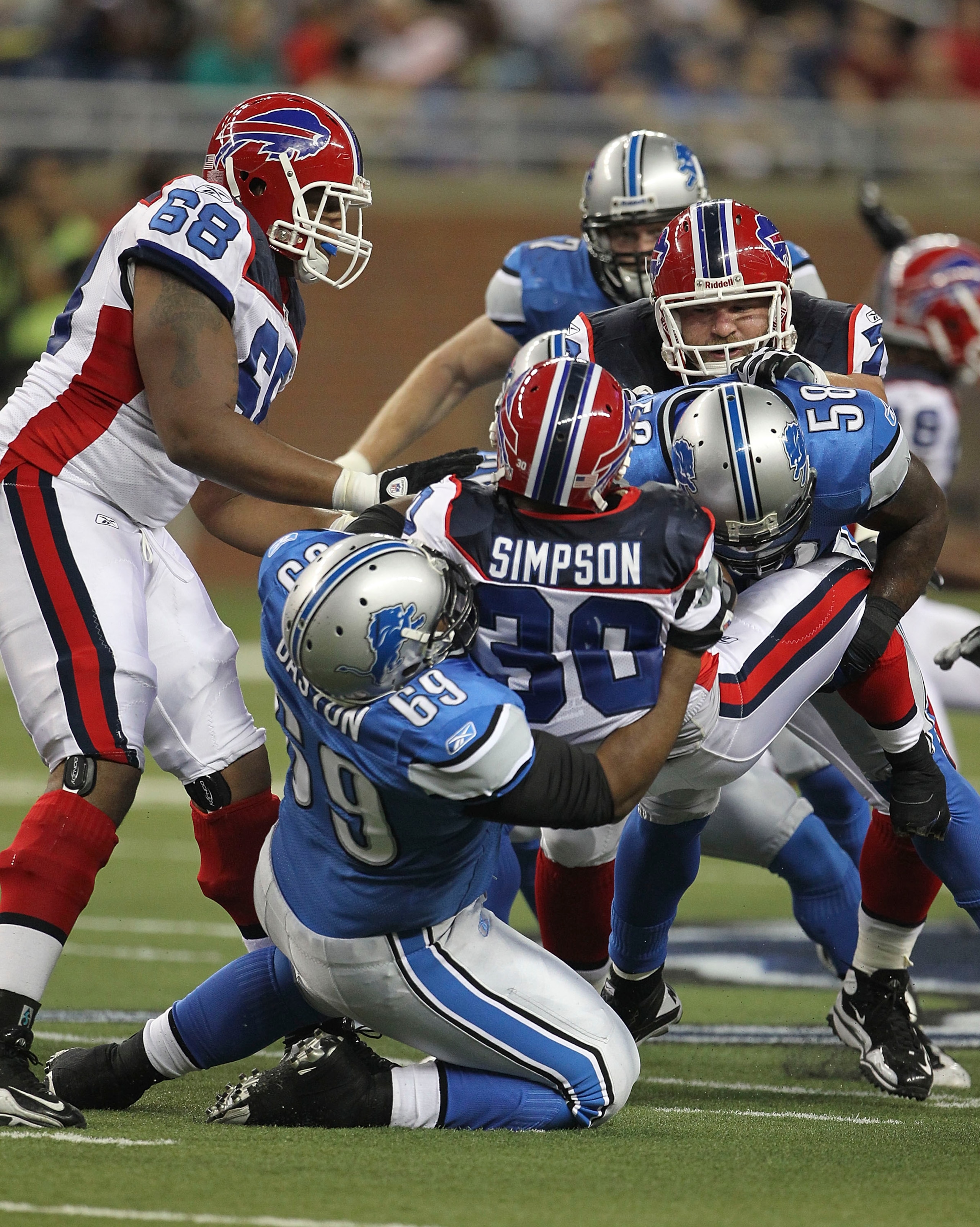 DETROIT - SEPTEMBER 02: Jaron Baston #69 and Ashlee Palmer #58 of the Detroit Lions make the stop on Chad Simpson #30 of the Buffalo Bills during the preseason game at Ford Field on September 2, 2010 in Detroit, Michigan.  (Photo by Leon Halip/Getty Image