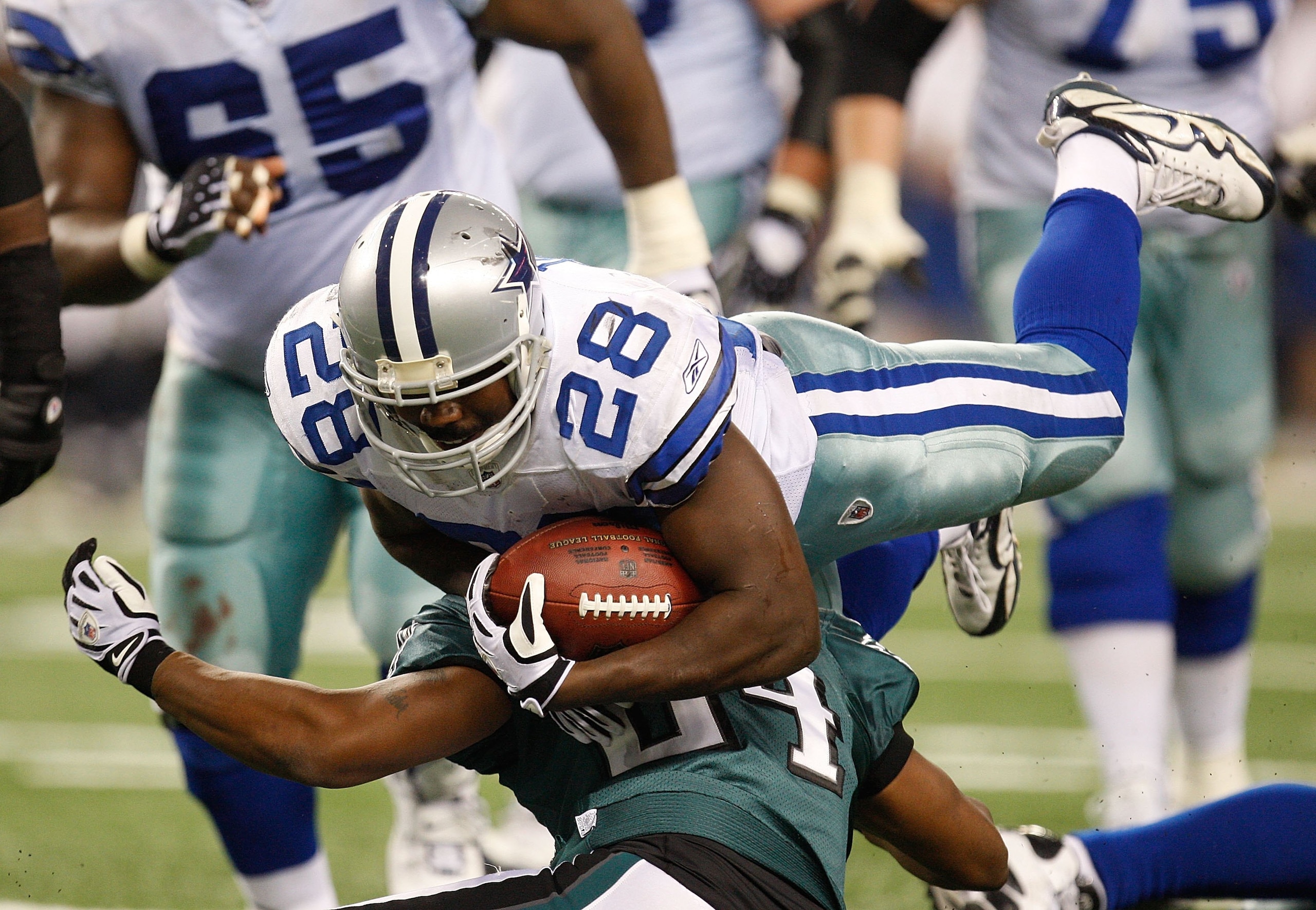 ARLINGTON, TX - JANUARY 09:  Running back Felix Jones #28 of the Dallas Cowboys runs the ball against the Philadelphia Eagles during the 2010 NFC wild-card playoff game at Cowboys Stadium on January 9, 2010 in Arlington, Texas.  (Photo by Ronald Martinez/