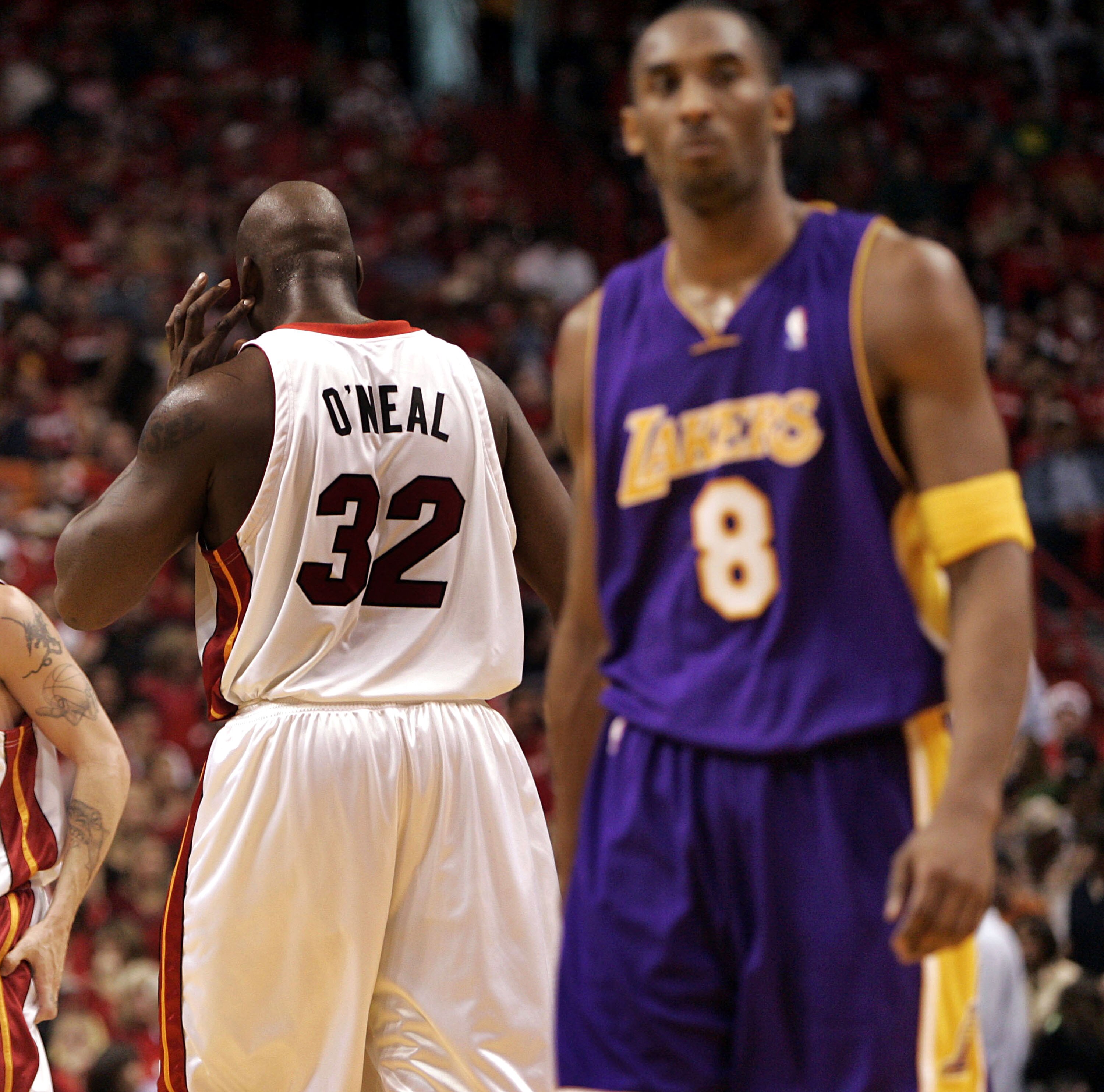 MIAMI - DECEMBER 25:  Center Shaquille O'Neal #32 of the Miami Heat keeps his back to guard Kobe Bryant #8 of the Los Angeles Lakers on December 25, 2005 at the American Airlines Arena in Miami, Florida.  NOTE TO USER: User expressly acknowledges and agre