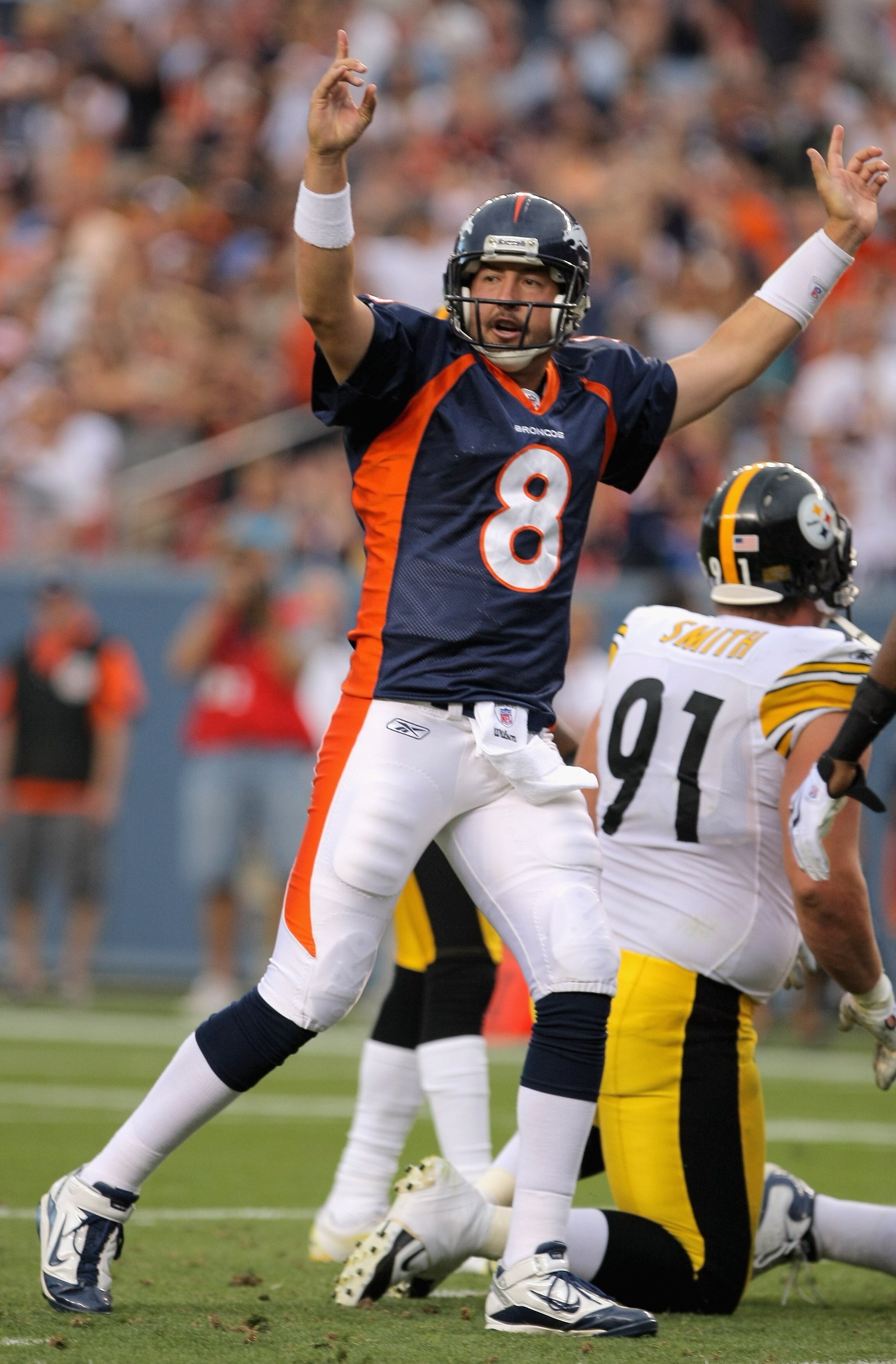 DENVER - AUGUST 29:  Quarterback Kyle Orton #8 of the Denver Broncos celebrates a touchdown by teammate LenDale White in the first quarter against the Pittsburgh Steelers during preseason NFL action at INVESCO Field at Mile High on August 29, 2010 in Denv