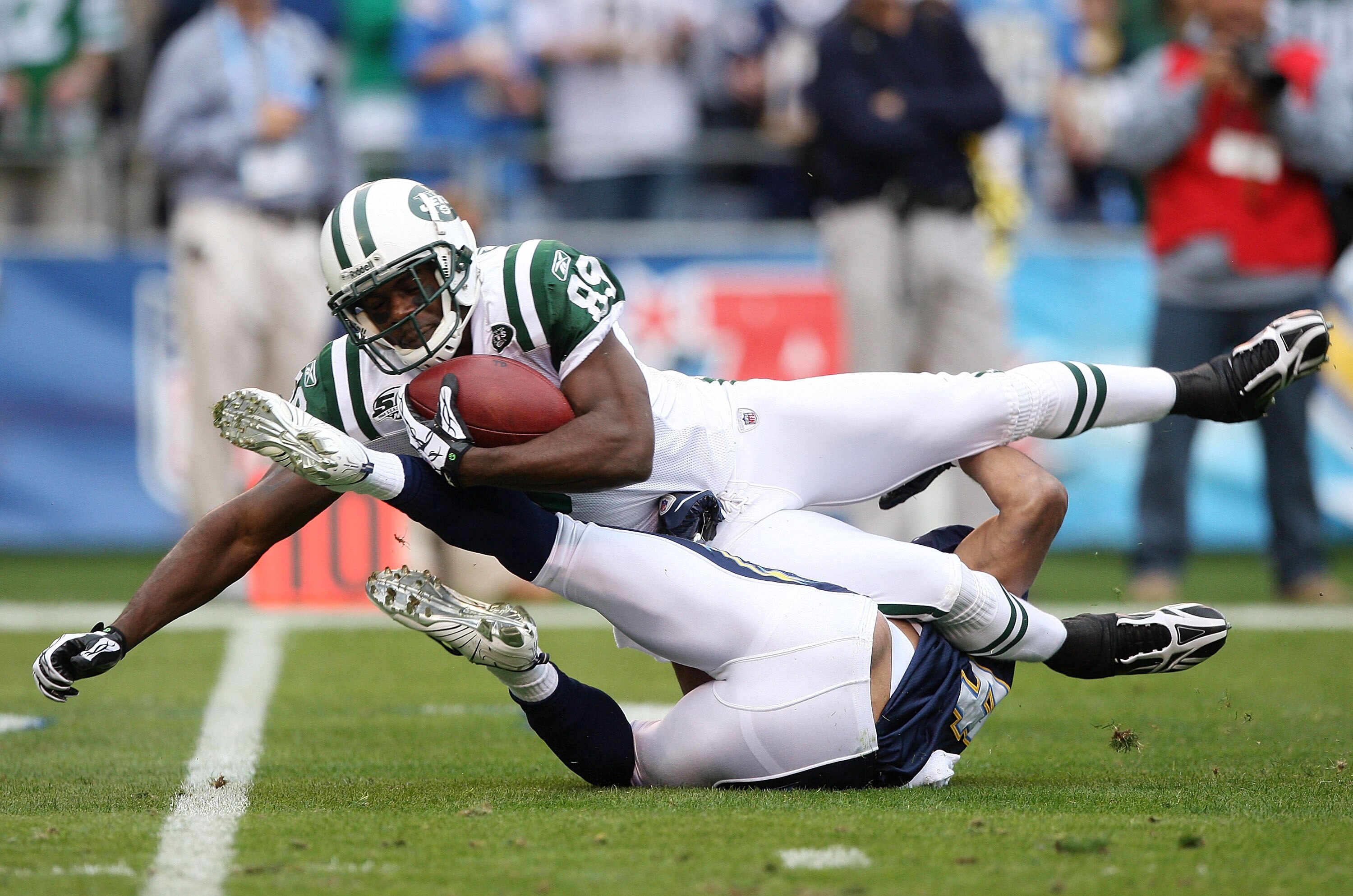 SAN DIEGO - JANUARY 17:  Wide receiver Jerricho Cotchery #89 of the New York Jets is tackled after making a catch against the San Diego Chargers during the AFC Divisional Playoff Game at Qualcomm Stadium on January 17, 2010 in San Diego, California.  (Pho