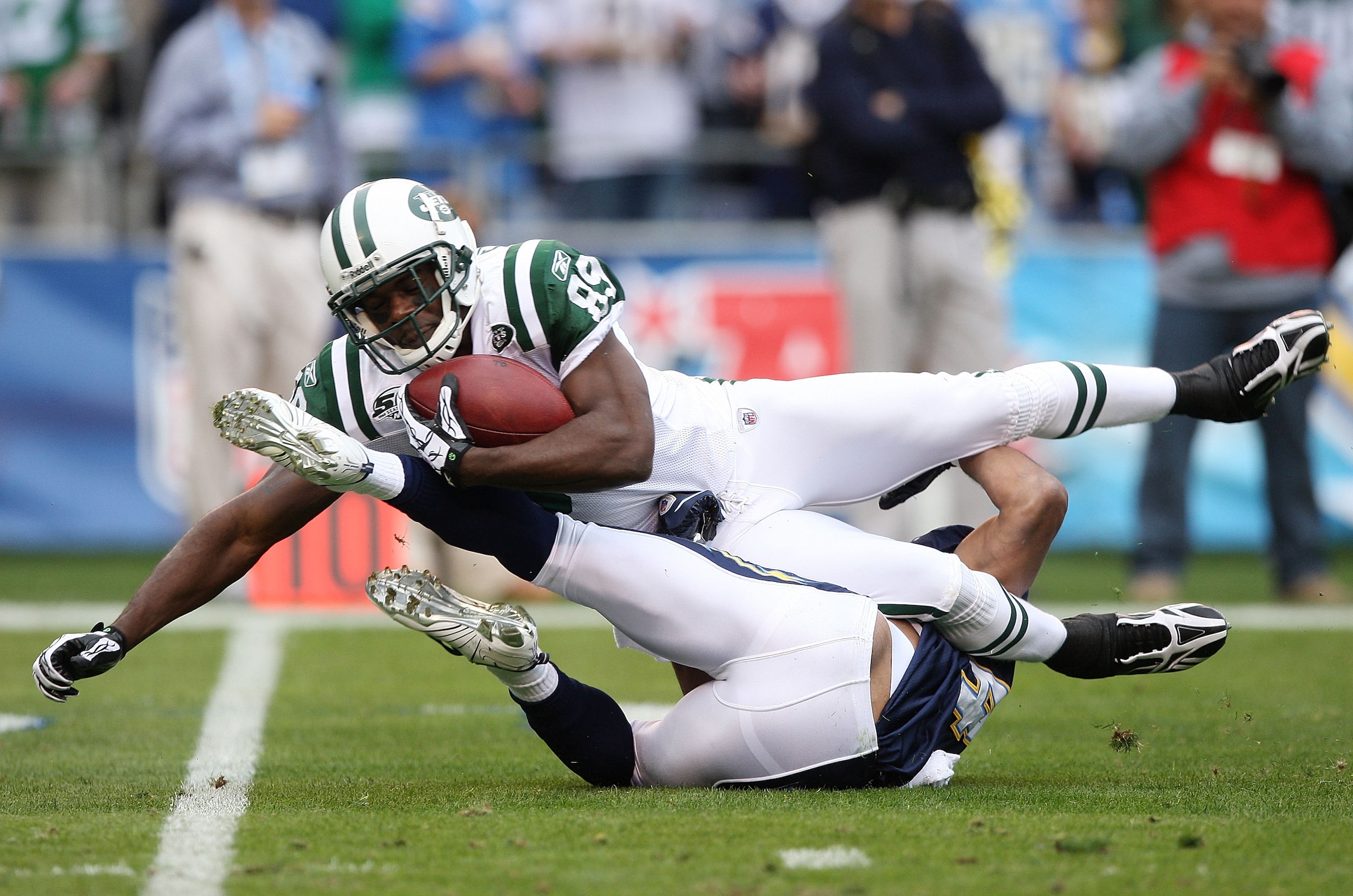 SAN DIEGO - JANUARY 17:  Wide receiver Jerricho Cotchery #89 of the New York Jets is tackled after making a catch against the San Diego Chargers during the AFC Divisional Playoff Game at Qualcomm Stadium on January 17, 2010 in San Diego, California.  (Pho
