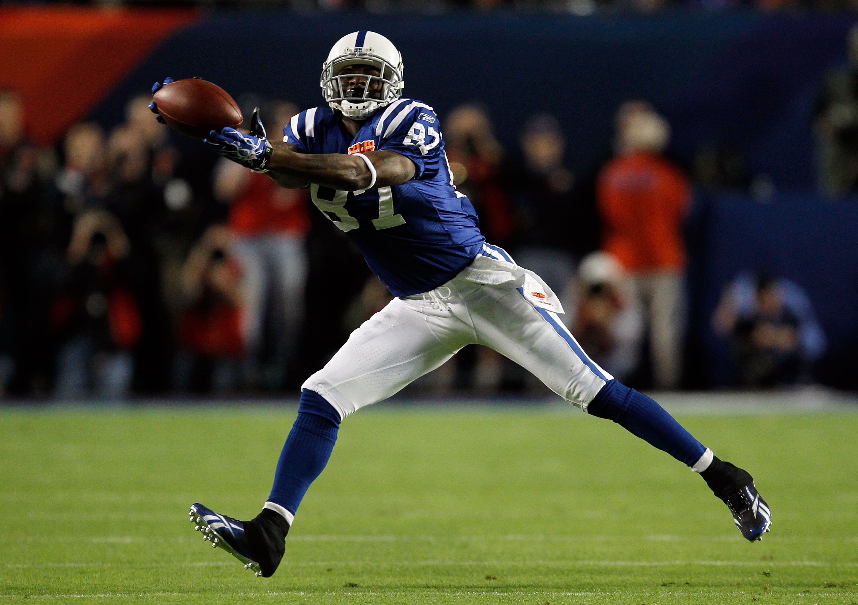 MIAMI GARDENS, FL - FEBRUARY 07: Reggie Wayne #87 reaches for the ball against the Indianapolis Colts of the New Orleans Saints during Super Bowl XLIV on February 7, 2010 at Sun Life Stadium in Miami Gardens, Florida.  (Photo by Jonathan Daniel/Getty Imag