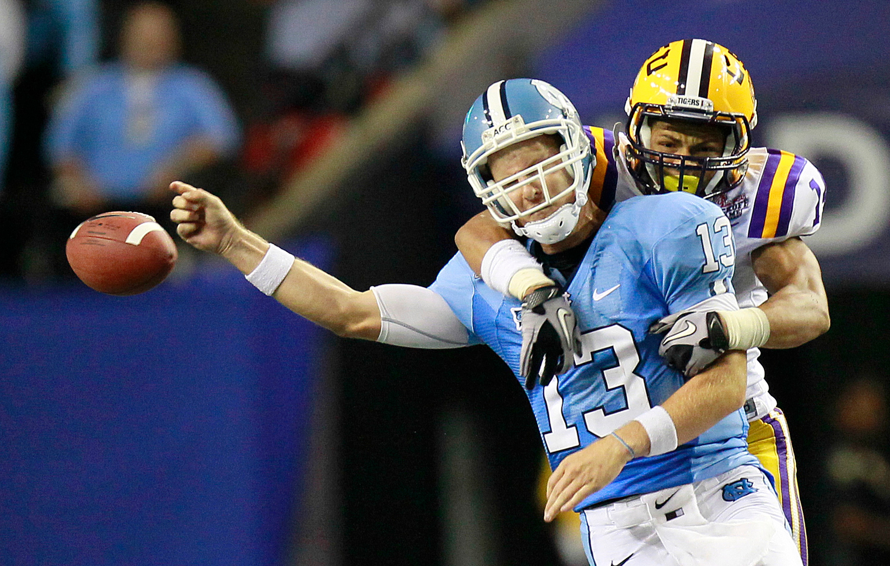 ATLANTA - SEPTEMBER 4: Tyrann Mathieu #14 of the LSU Tigers forces a fumble by quarterback T.J. Yates #13 of the North Carolina Tar Heels at the Georgia Dome September 4, 2010 in Atlanta, Georgia.  (Photo by Kevin C. Cox/Getty Images)