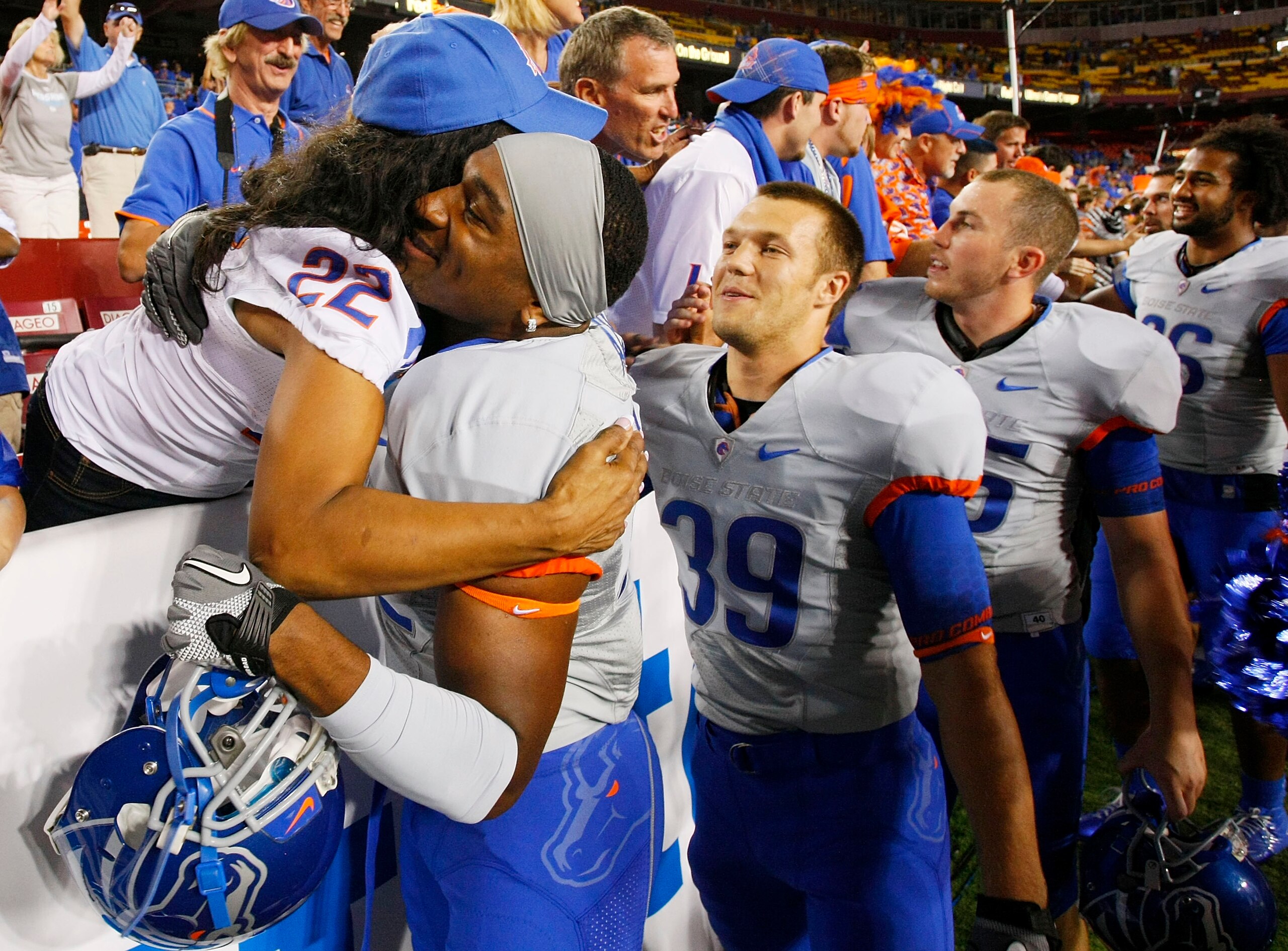LANDOVER, MD - SEPTEMBER 06:  Linebacker #52 Derrell Acrey of the Boise State Broncos hugs a fan after the Broncos defeated the Virginia Tech Hokies 33-30 at FedExField on September 6, 2010 in Landover, Maryland.  (Photo by Geoff Burke/Getty Images)