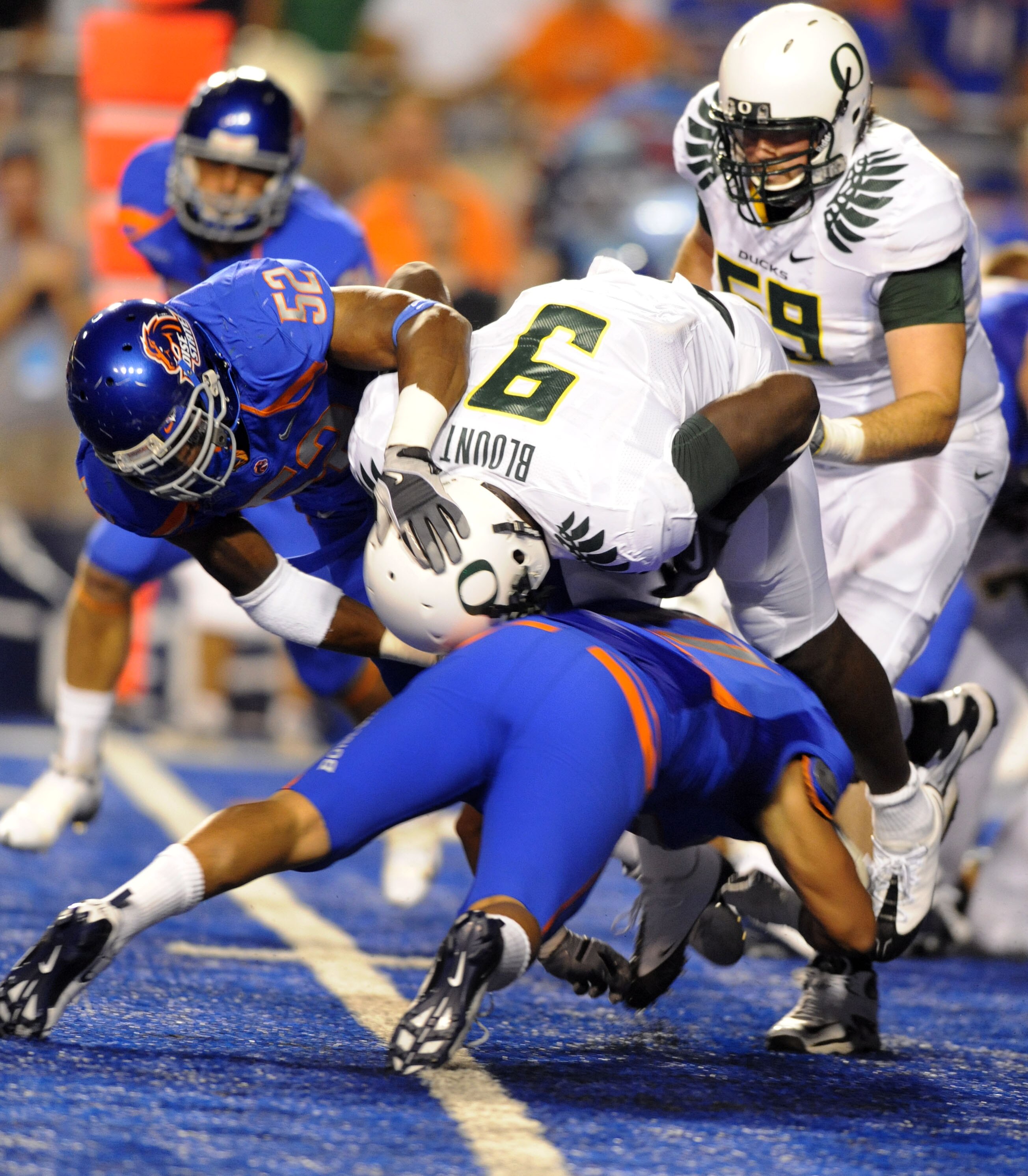 BOISE, ID - SEPTEMBER 3:  LaGarrette Blount #9 of the Oregon Ducks is upended by Winston Venable #17 and Derrell Acrey #52 of the Boise State Broncos the first quarter of the game on September 3, 2009 at Bronco Stadium in Boise, Idaho. (Photo by Steve Dyk
