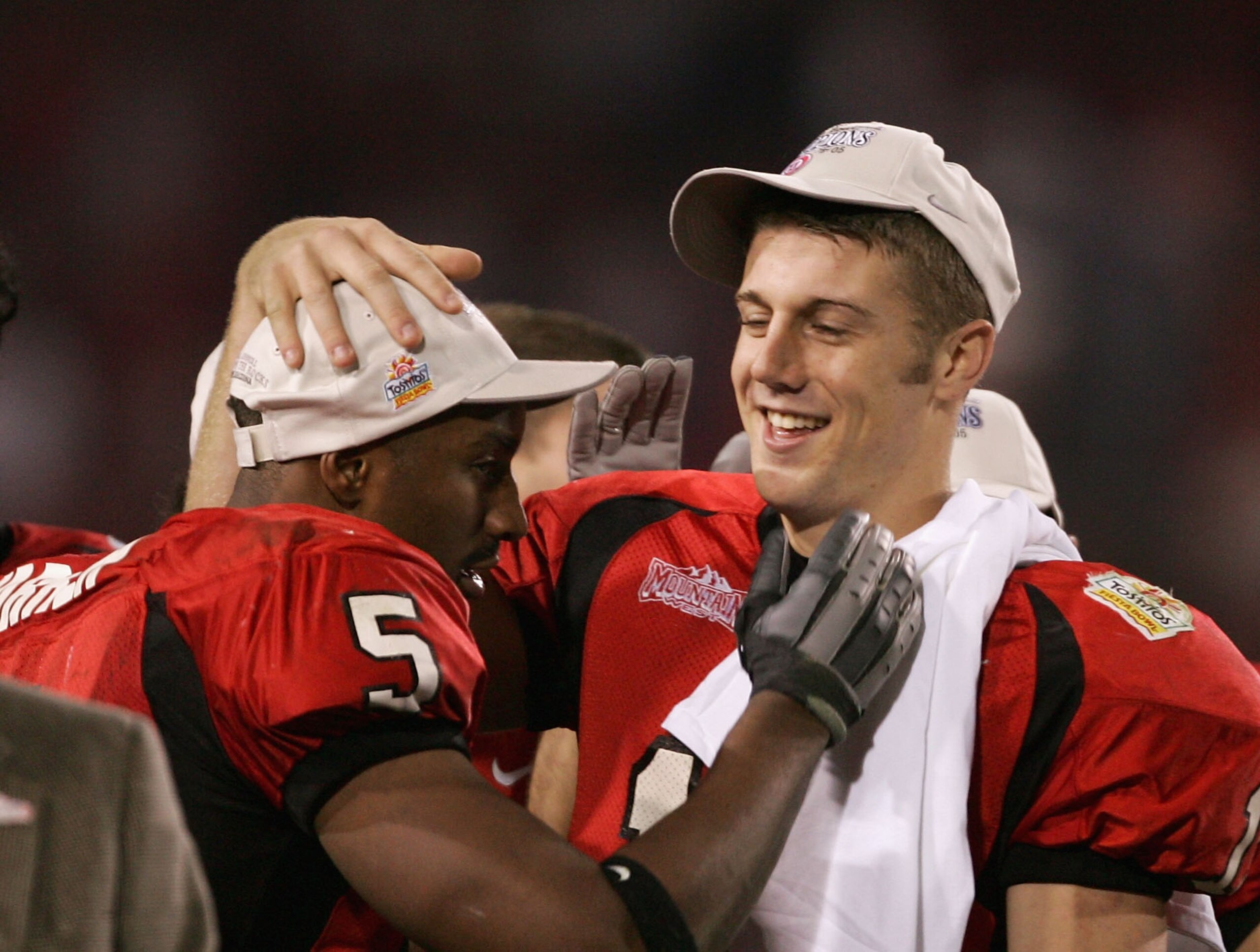 TEMPE, AZ - JANUARY 1:  Paris Warren #5 and quarterback Alex Smith #11 celebrate after their team defeated Pittsburgh 35-7 in the Tostito's Fiesta Bowl at the Sun Devil Stadium on January 1, 2005 in Tempe, Arizona. (Photo by Harry How/Getty Images).