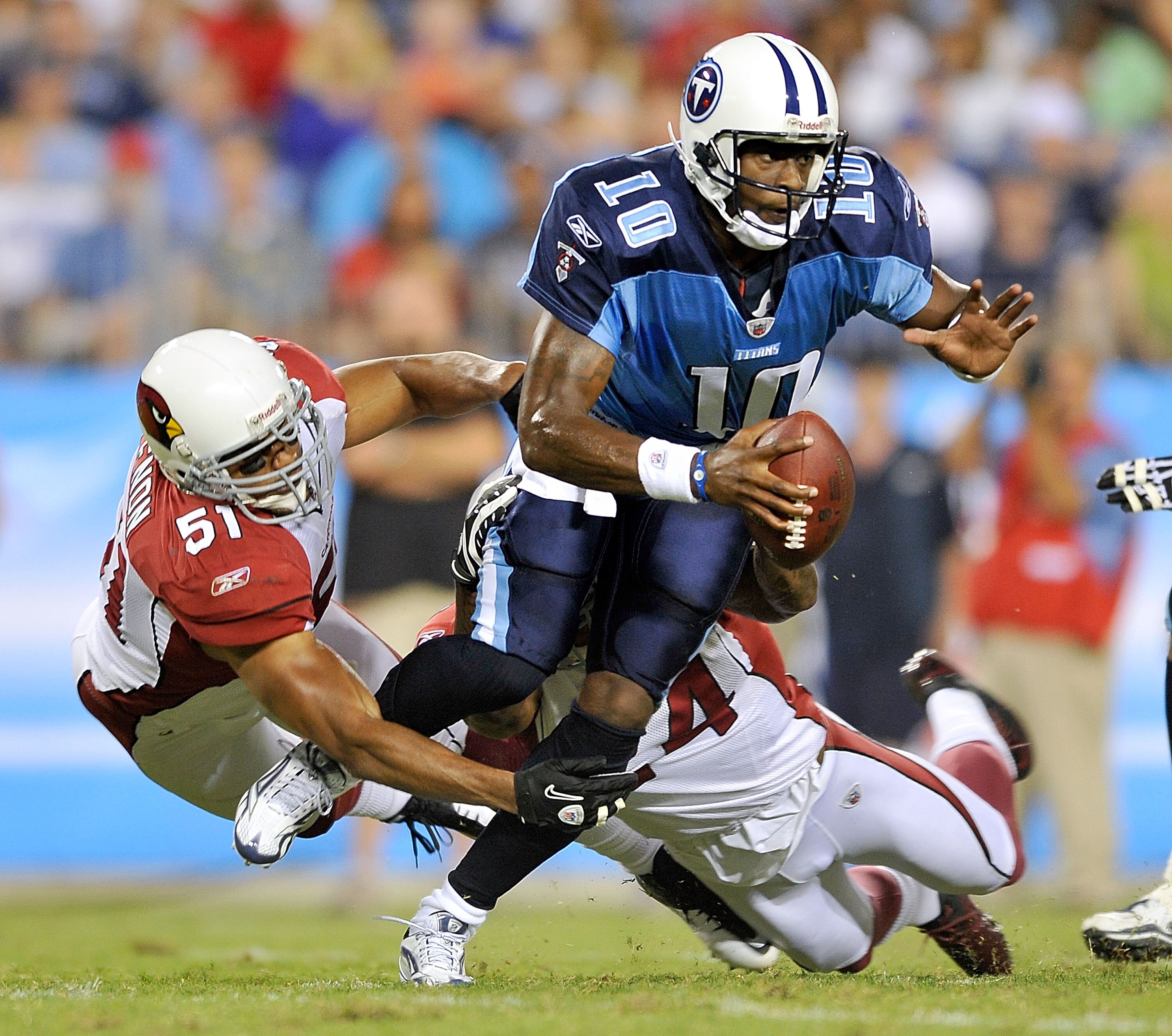 NASHVILLE, TN - AUGUST 23: Vince Young #10 of the Tennessee Titans scrambles away from Paris Lenon #51 and Adrian Wilson #24 of the Arizona Cardinals during the first half of a preseason game at LP Field on August 23, 2010 in Nashville, Tennessee. (Phot NASHVILLE, TN - AUGUST 23: Vince Young #10 of the Tennessee Titans scrambles away from Paris Lenon #51 and Adrian Wilson #24 of the Arizona Cardinals during the first half of a preseason game at LP Field on August 23, 2010 in Nashville, Tennessee. (Phot