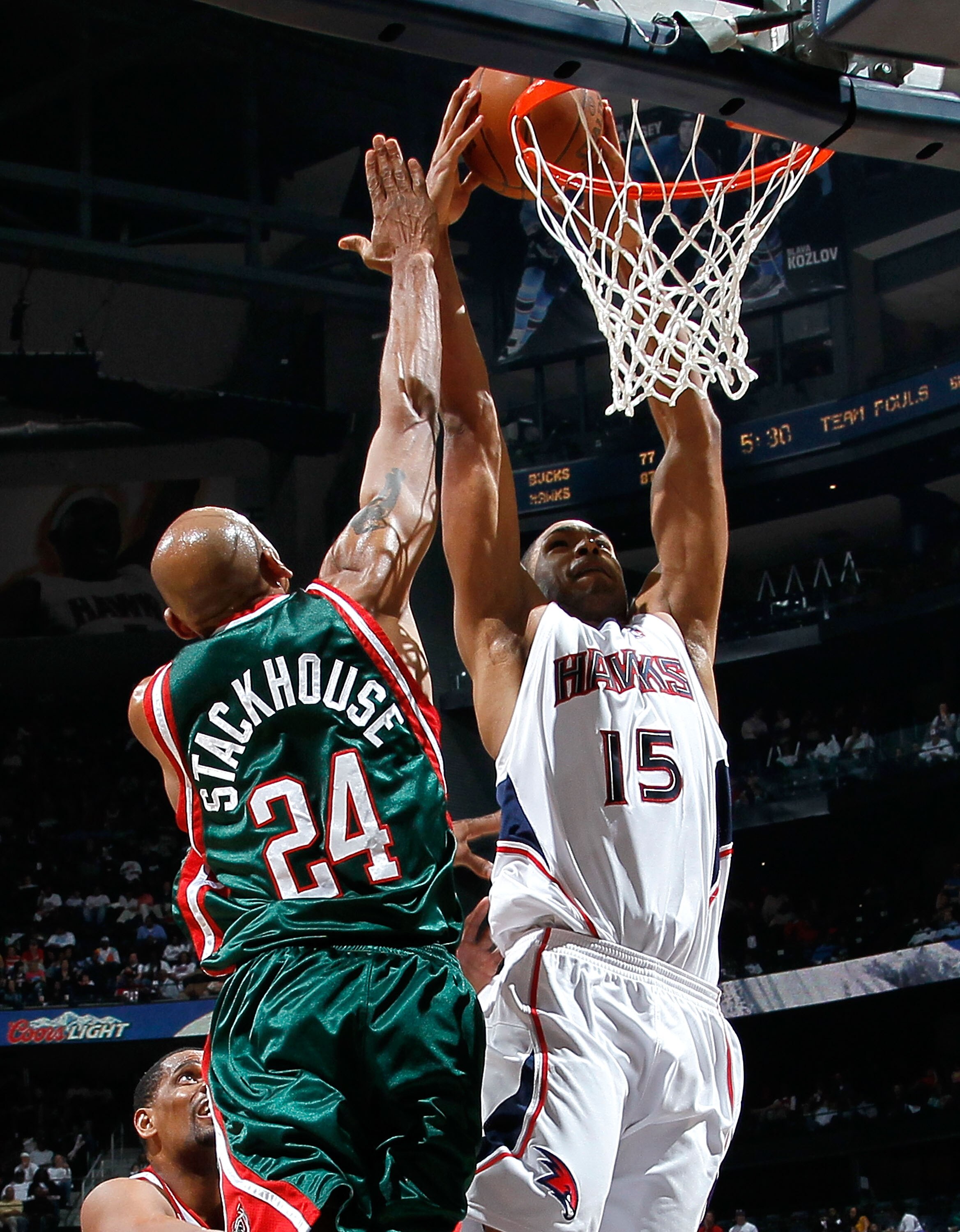 ATLANTA - APRIL 20:  Al Horford #15 of the Atlanta Hawks dunks and draws a foul from Jerry Stackhouse #24 of the Milwaukee Bucks at Philips Arena on April 20, 2010 in Atlanta, Georgia.  NOTE TO USER: User expressly acknowledges and agrees that, by downloa