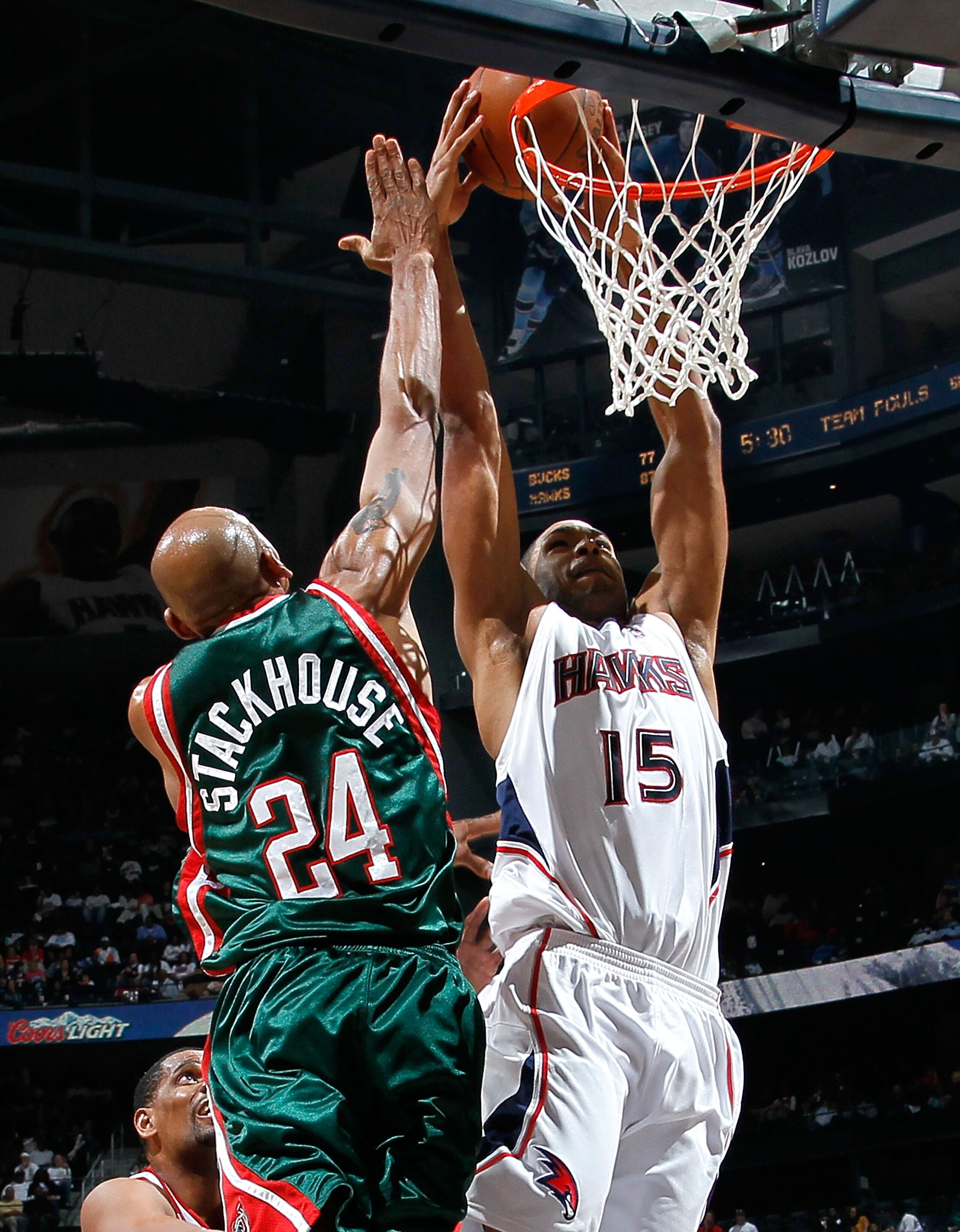 ATLANTA - APRIL 20:  Al Horford #15 of the Atlanta Hawks dunks and draws a foul from Jerry Stackhouse #24 of the Milwaukee Bucks at Philips Arena on April 20, 2010 in Atlanta, Georgia.  NOTE TO USER: User expressly acknowledges and agrees that, by downloa