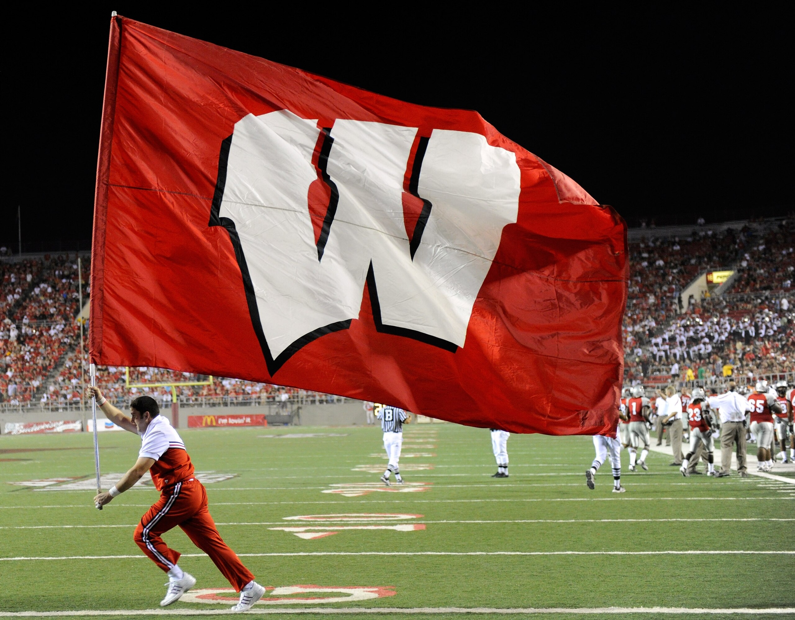 LAS VEGAS - SEPTEMBER 04: A Wisconsin Badgers cheerleader runs a flag through the end zone after a Wisconsin touchdown against the UNLV Rebels at Sam Boyd Stadium September 4, 2010 in Las Vegas, Nevada. Wisconsin won 41-21. (Photo by Ethan Miller/Getty LAS VEGAS - SEPTEMBER 04: A Wisconsin Badgers cheerleader runs a flag through the end zone after a Wisconsin touchdown against the UNLV Rebels at Sam Boyd Stadium September 4, 2010 in Las Vegas, Nevada. Wisconsin won 41-21. (Photo by Ethan Miller/Getty