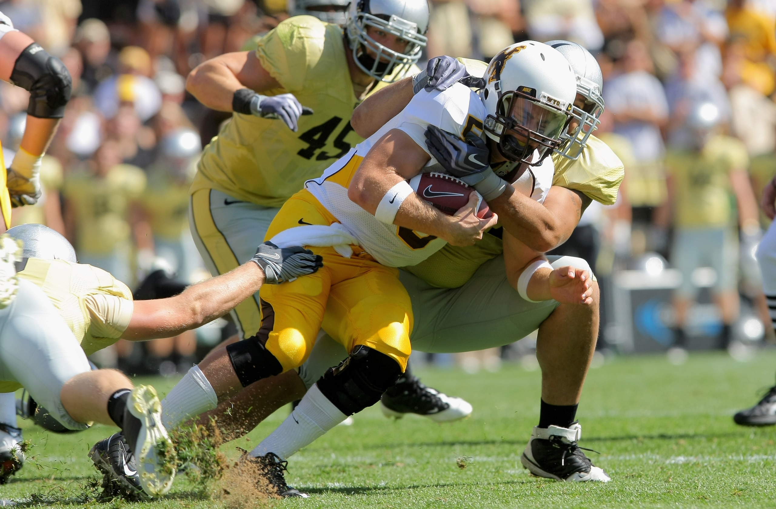 BOULDER, CO - SEPTEMBER 19: Quarterback Austyn Carta-Samuels #5 of the Wyoming Cowboys is tackled by Taj Kaynor #97 of the Colorado Buffaloes at Folsom Field on September 19, 2009 in Boulder, Colorado. (Photo by Doug Pensinger/Getty Images) BOULDER, CO - SEPTEMBER 19: Quarterback Austyn Carta-Samuels #5 of the Wyoming Cowboys is tackled by Taj Kaynor #97 of the Colorado Buffaloes at Folsom Field on September 19, 2009 in Boulder, Colorado. (Photo by Doug Pensinger/Getty Images)