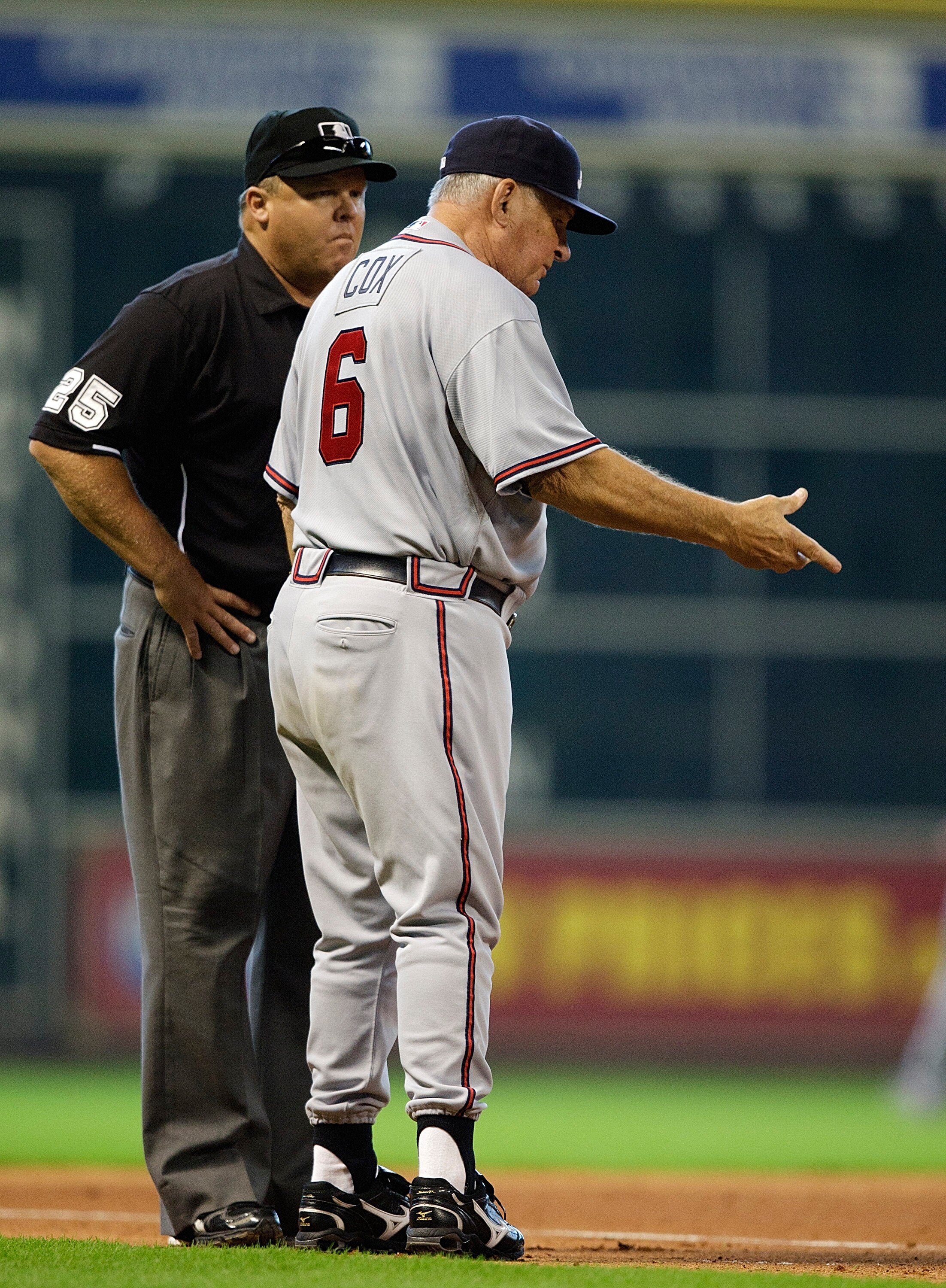 HOUSTON - AUGUST 11:  Manager Bobby Cox #6 of the Atlanta Braves argues with third base umpire Fieldin Culbreth as to whether Michael Bourn of the Houston Astros was safe as he stole third base at Minute Maid Park on August 11, 2010 in Houston, Texas.  (P