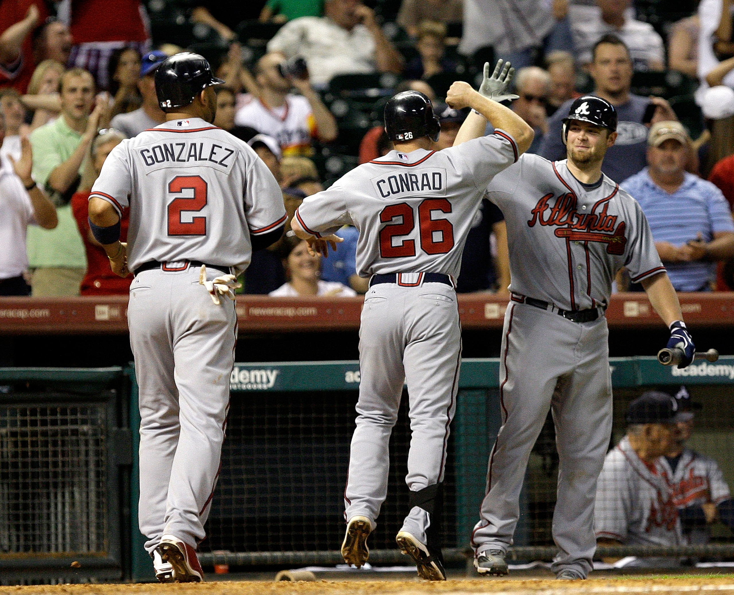 HOUSTON - AUGUST 10:  Brooks Conrad #26 of the Atlanta Braves is congratulated by Alex Gonzalez #2 after hitting a two run home run in the ninth inning against Matt Lindstrom of the Houston Astros at Minute Maid Park on August 10, 2010 in Houston, Texas.