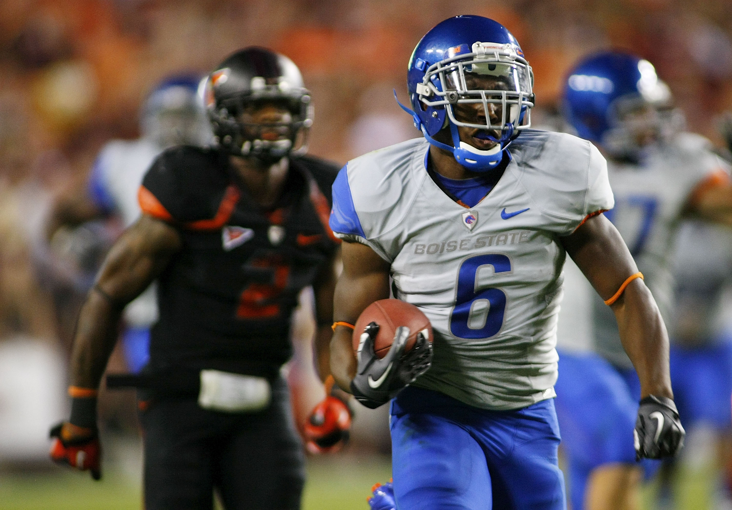 LANDOVER, MD - SEPTEMBER 06:  Running back #6 D.J. Harper of the Boise State Broncos runs for a touchdown as  safety #2 Davon Morgan of the Virginia Tech Hokies chases at FedExField on September 6, 2010 in Landover, Maryland.  (Photo by Geoff Burke/Getty