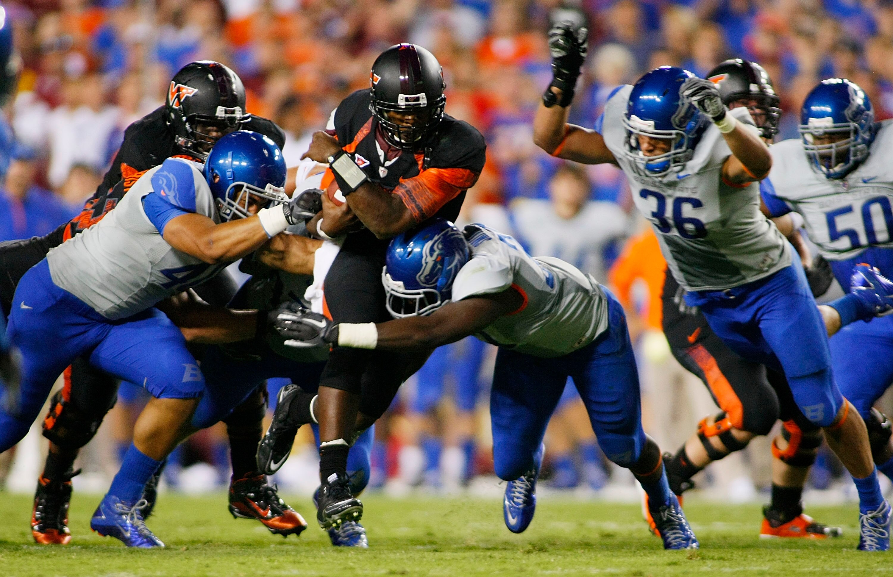 LANDOVER, MD - SEPTEMBER 06:  Quarterback #5 Tyrod Taylor of the Virginia Tech Hokies is tackled by defensive end #40 Tyrone Crawford, linebacker #33 Tommy Smith, and linebacker Aaron Tevis of the Boise State Broncos at FedExField on September 6, 2010 in