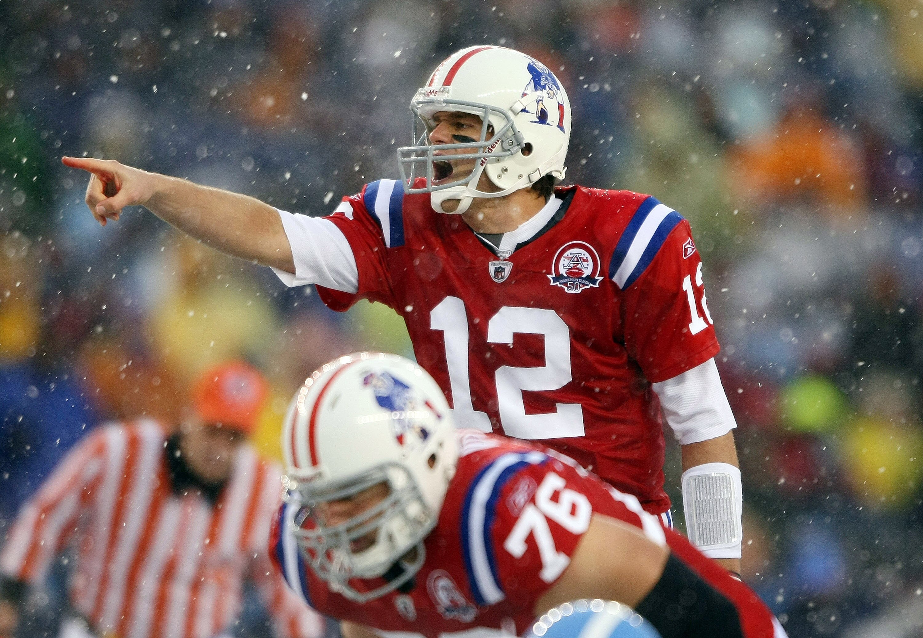 FOXBORO, MA - OCTOBER 18:  Quarterback Tom Brady #12 of the New England Patriots calls out the play as Sebastian Vollmer #76 listens in the first quarter against the Tennessee Titans on October 18, 2009 at Gillette Stadium in Foxboro, Massachusetts.  (Pho