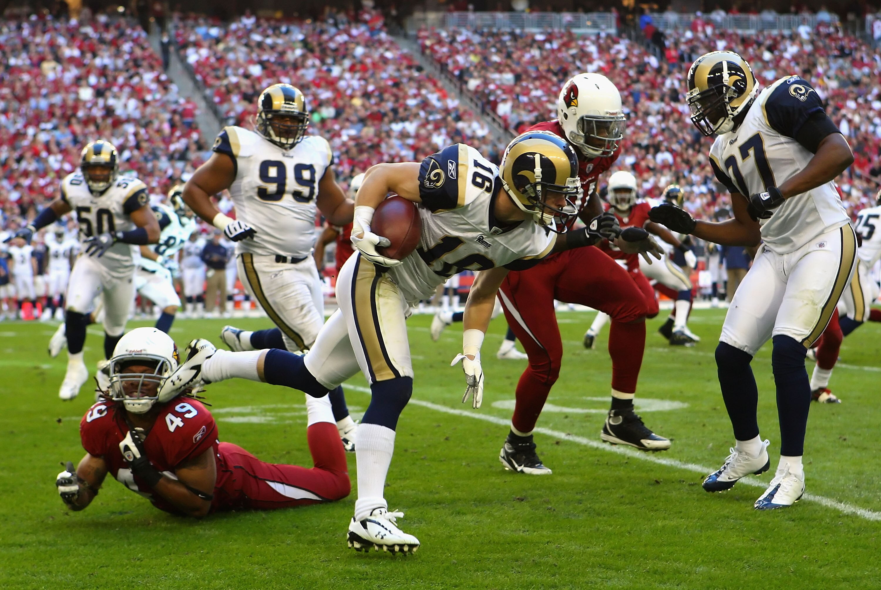GLENDALE, AZ - DECEMBER 27:  Wide receiver Danny Amendola #16 of the St. Louis Rams runs with the ball after a reception past Rashad Johnson #49 of the Arizona Cardinals during the second quarter of the NFL game at the Universtity of Phoenix Stadium on De
