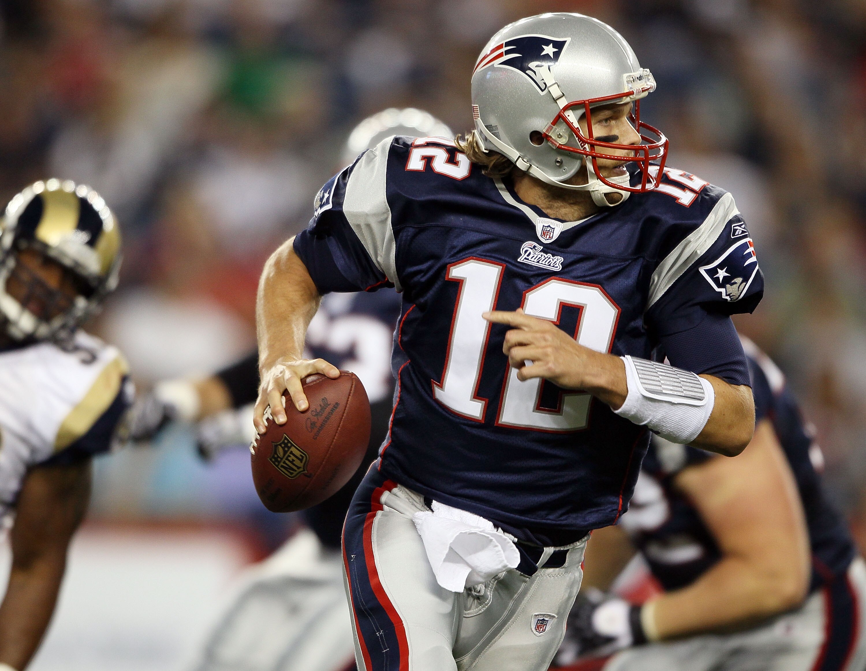 FOXBORO, MA - AUGUST 26:  Tom Brady #12 of the New England Patriots scrambles in the first half against the St. Louis Rams on August 26, 2010 at Gillette Stadium in Foxboro, Massachusetts.  (Photo by Elsa/Getty Images)