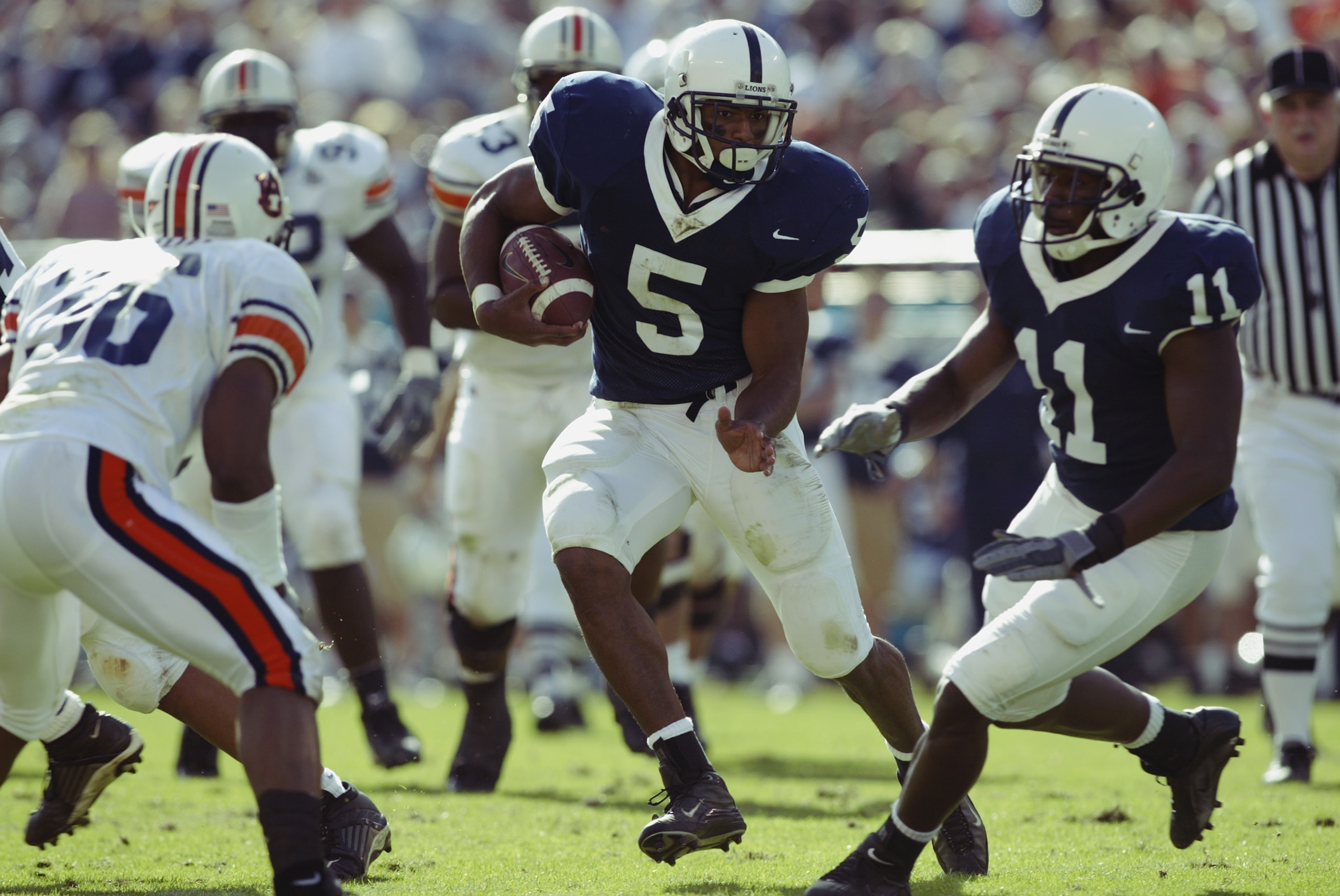 ORLANDO, FL - JANUARY 1: Tailback Larry Johnson #5 of the Pennsylvania State University Lions carries the ball against the Auburn University Tigers during the Capital One Bowl at Florida Citrus Bowl Stadium on January 1, 2003 in Orlando, Florida. Auburn ORLANDO, FL - JANUARY 1: Tailback Larry Johnson #5 of the Pennsylvania State University Lions carries the ball against the Auburn University Tigers during the Capital One Bowl at Florida Citrus Bowl Stadium on January 1, 2003 in Orlando, Florida. Auburn