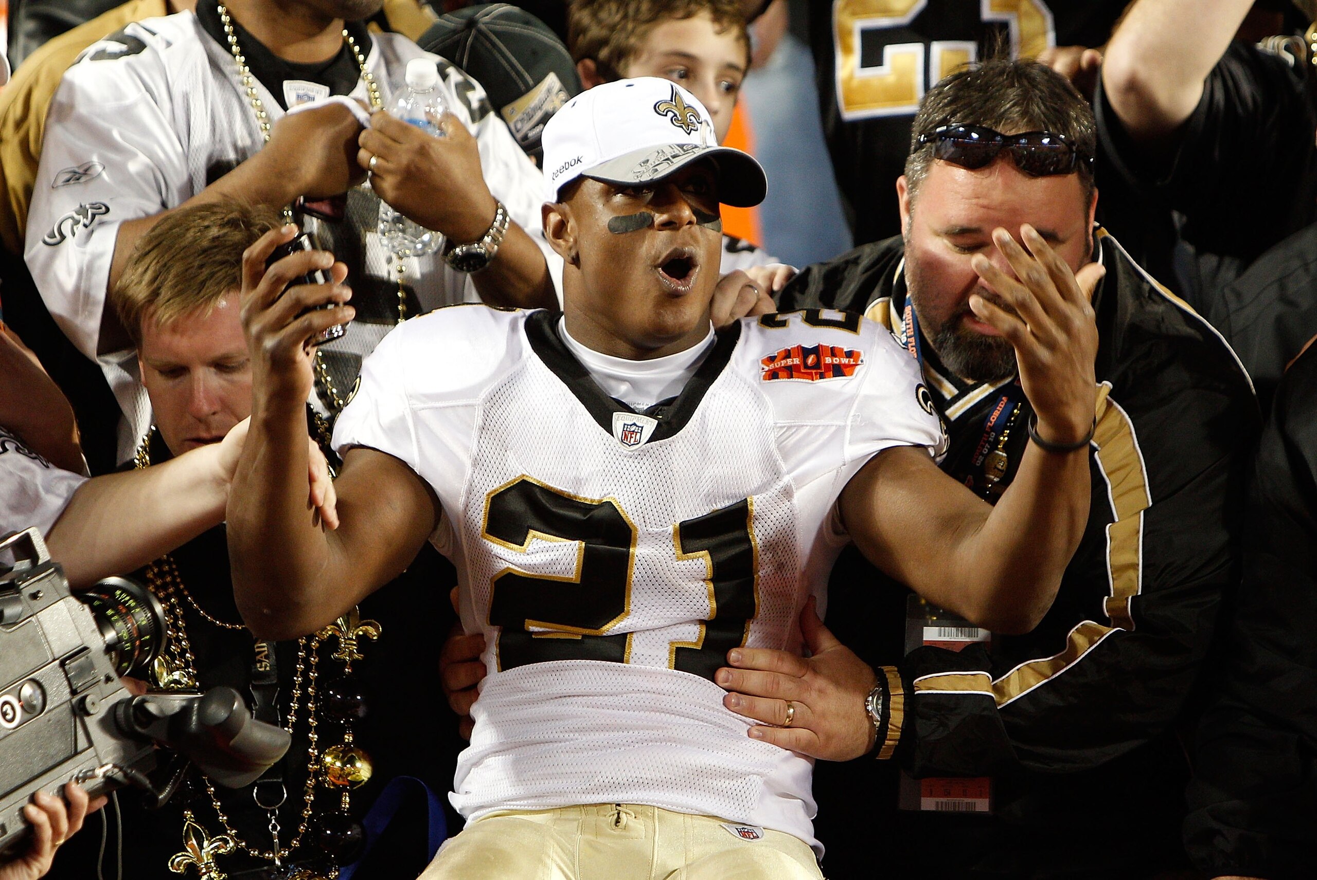 MIAMI GARDENS, FL - FEBRUARY 07:  Mike Bell # 21 of the New Orleans Saints celebrates with fans after defeating the Indianapolis Colts during Super Bowl XLIV on February 7, 2010 at Sun Life Stadium in Miami Gardens, Florida.  (Photo by Chris Graythen/Gett