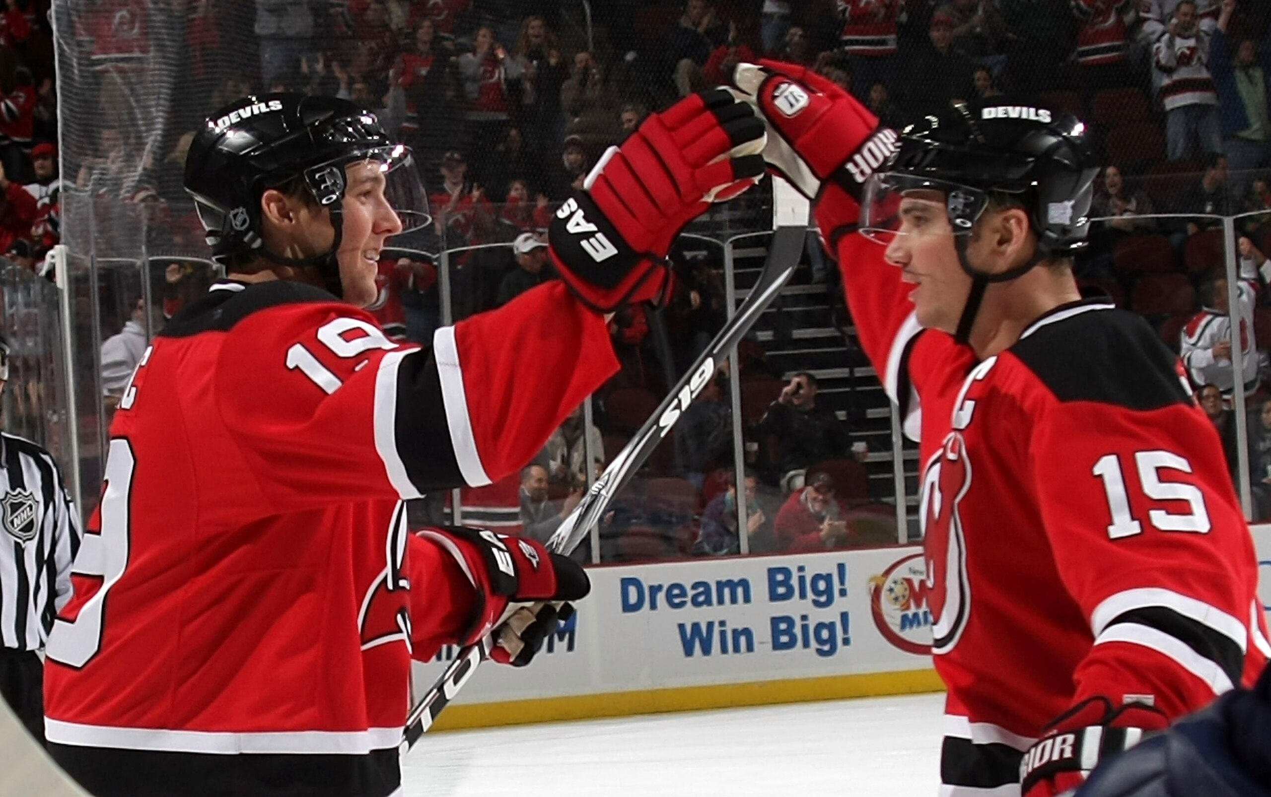 NEWARK, NJ - OCTOBER 16: Jamie Lanngenbrunner #15 (R) of the New Jersey Devils congratulates Travis Zajac #19 on his second period goal against the Atlanta Thrashers at the Prudential Center on October 16, 2009 in Newark, New Jersey. (Photo by Bruce Benne