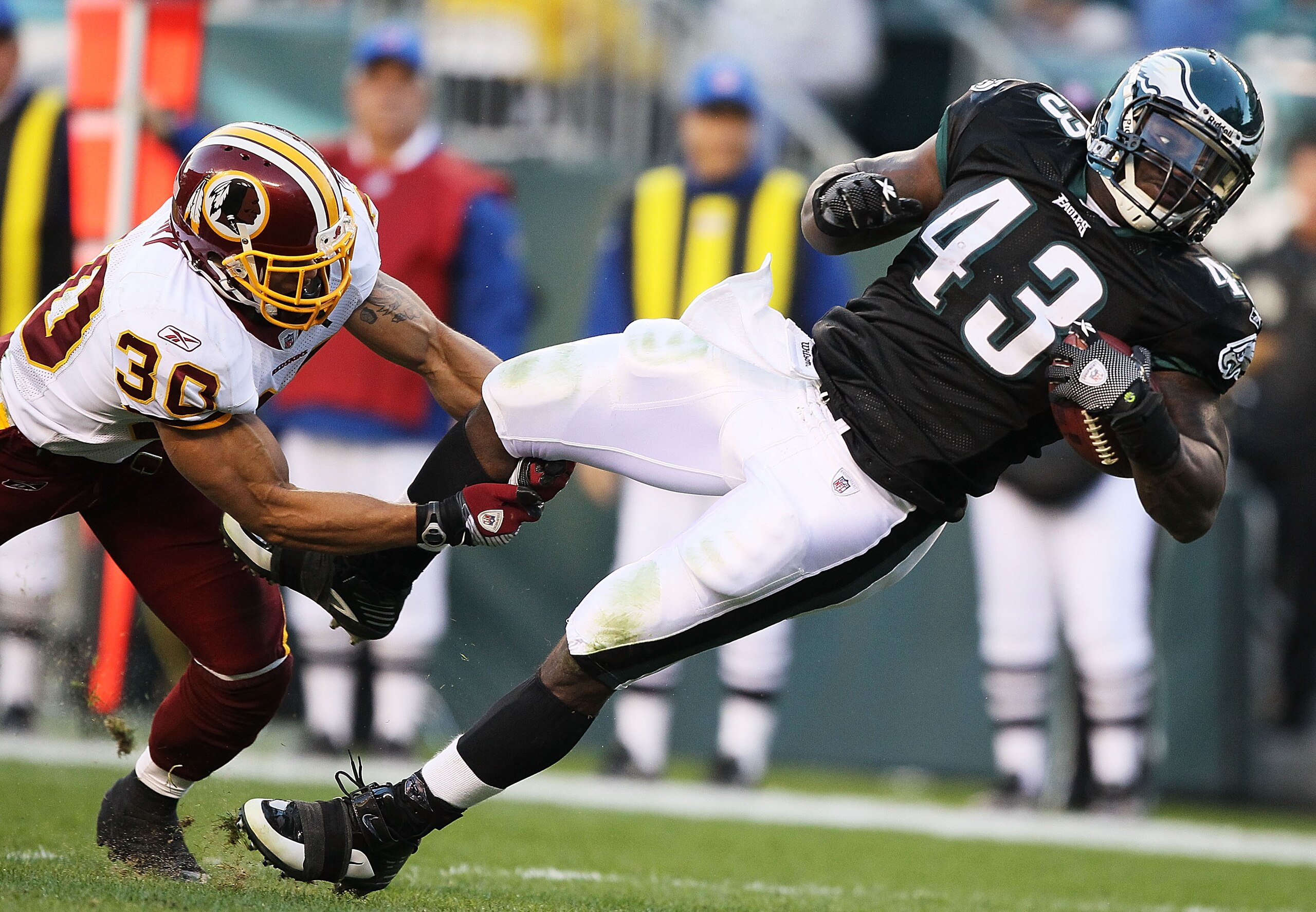 PHILADELPHIA - NOVEMBER 29:  Leonard Weaver #43 of the Philadelphia Eagles is tackled by LaRon Landry #30 of the Washington Redskins during their game at Lincoln Financial Field on November 29, 2009 in Philadelphia, Pennsylvania.  (Photo by Al Bello/Getty