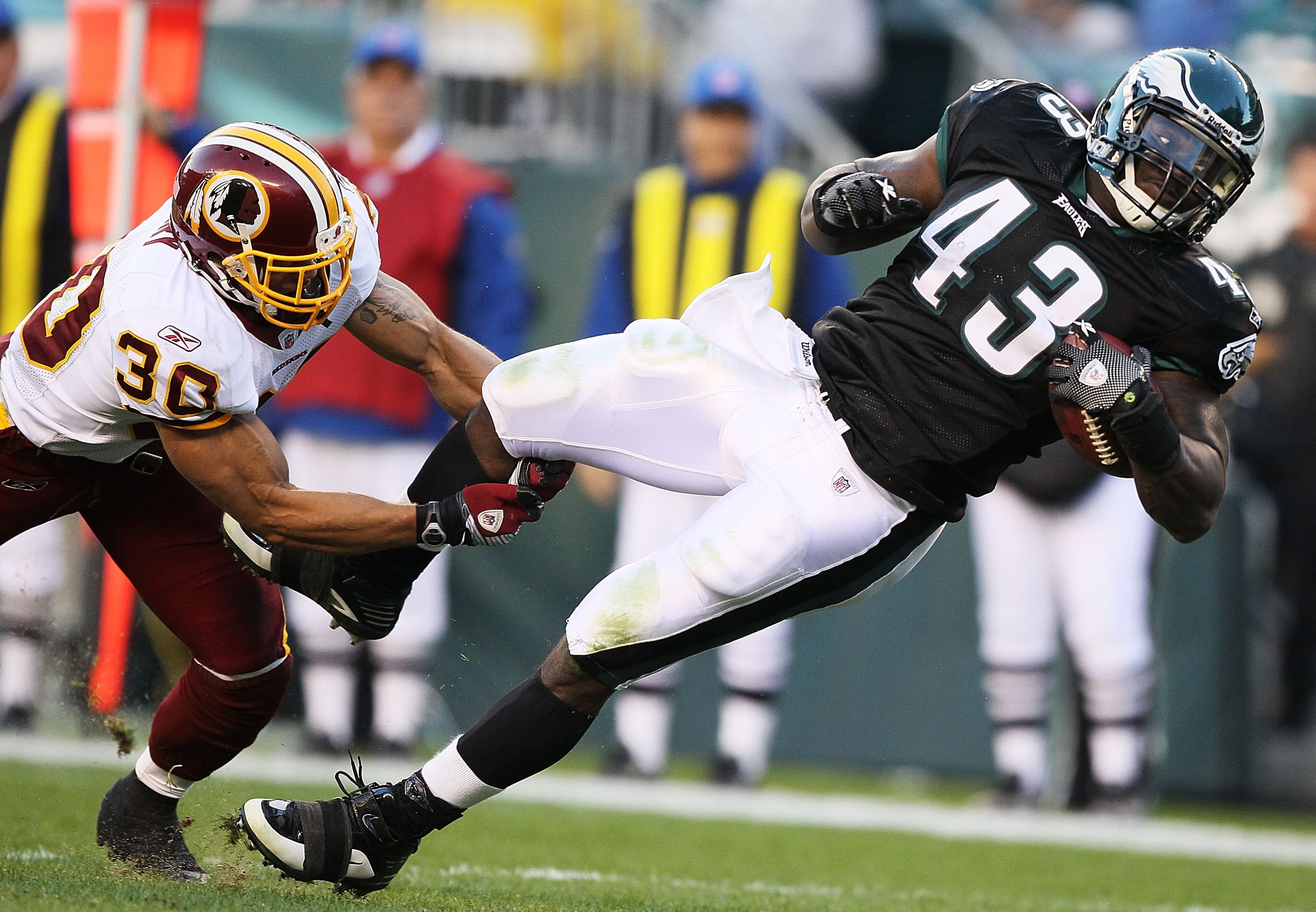 PHILADELPHIA - NOVEMBER 29:  Leonard Weaver #43 of the Philadelphia Eagles is tackled by LaRon Landry #30 of the Washington Redskins during their game at Lincoln Financial Field on November 29, 2009 in Philadelphia, Pennsylvania.  (Photo by Al Bello/Getty