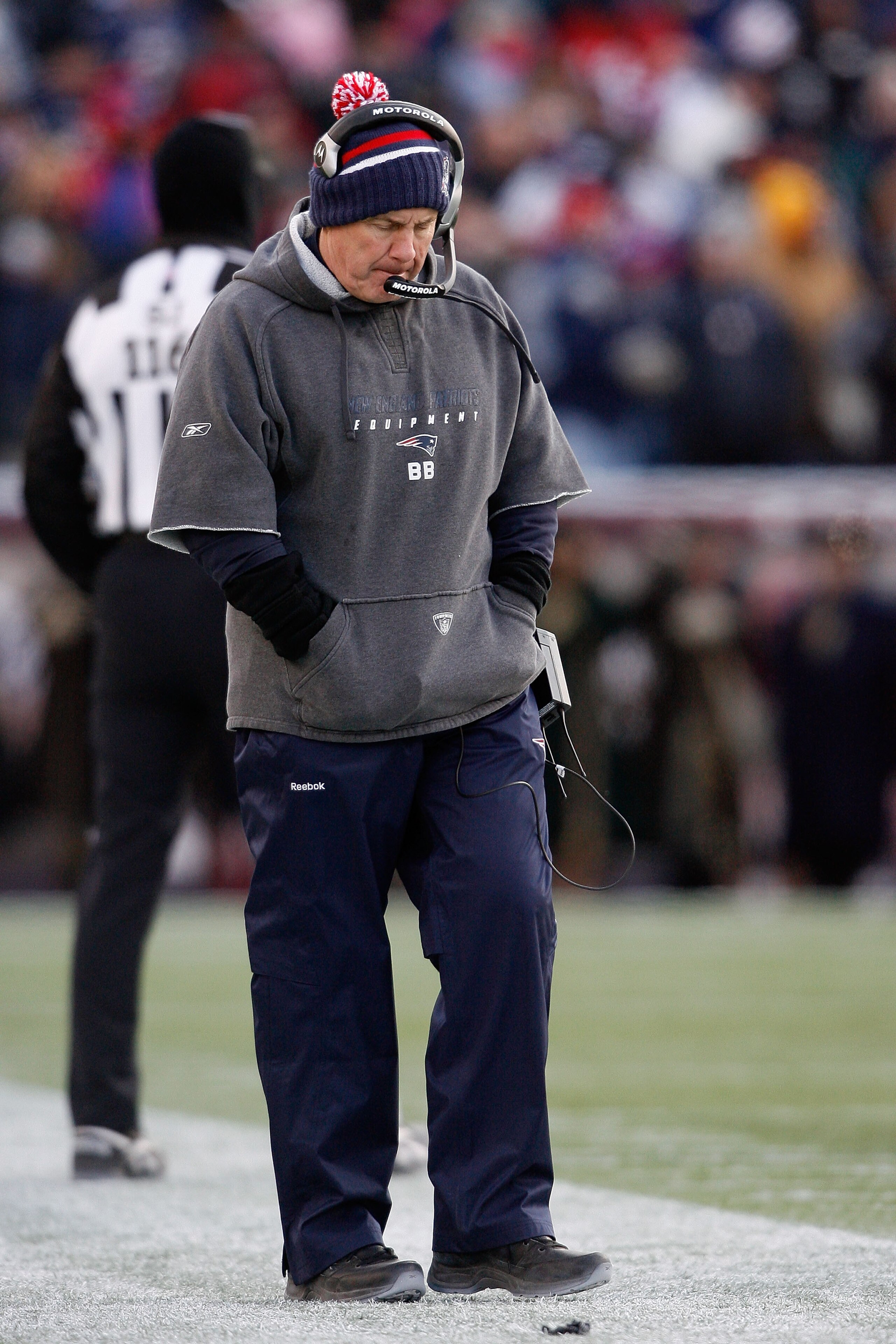 FOXBORO, MA - JANUARY 10:  Head coach Bill Belichick of the New England Patriots stands on the sideline with his head down against the Baltimore Ravens during the 2010 AFC wild-card playoff game at Gillette Stadium on January 10, 2010 in Foxboro, Massachu