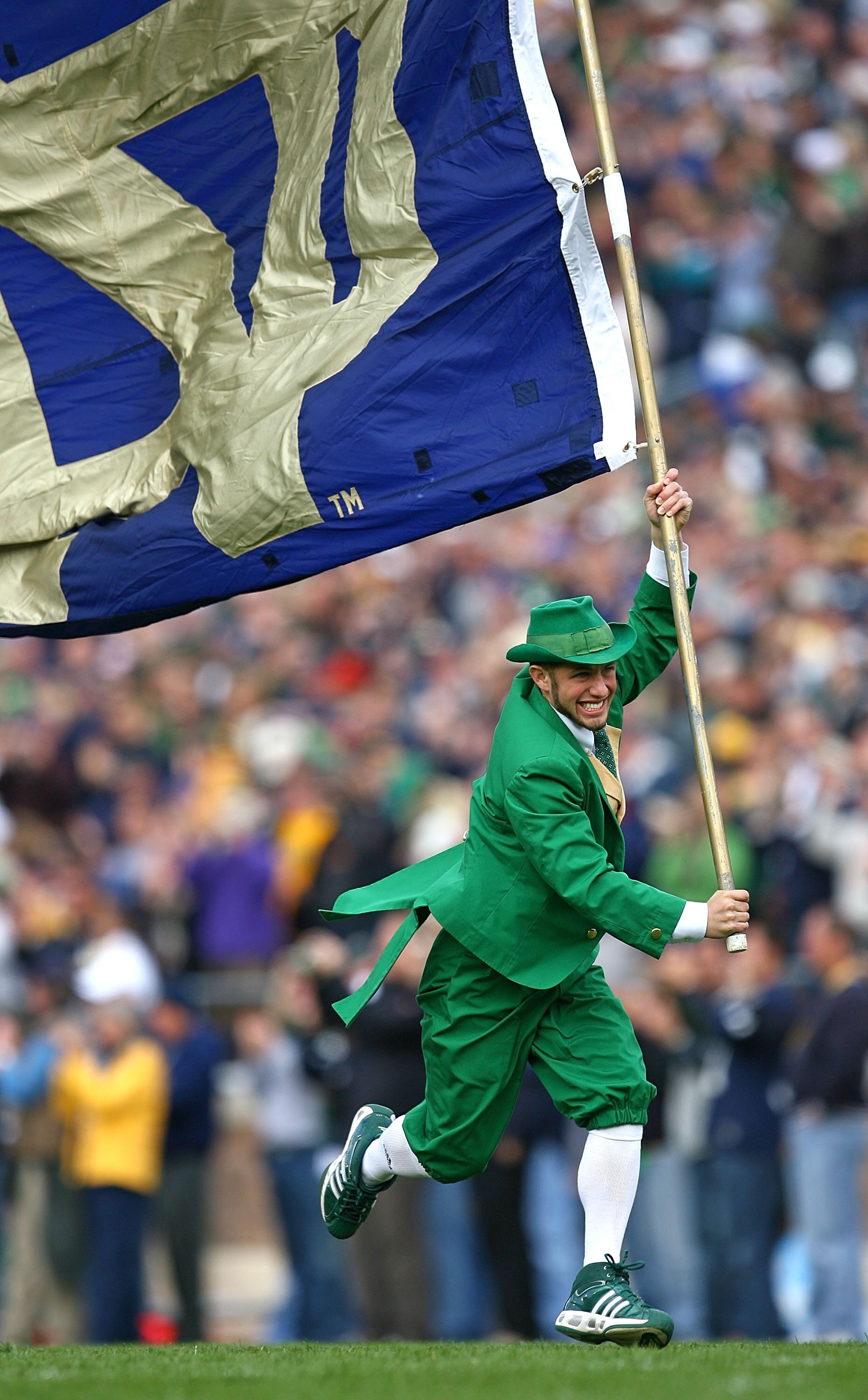 SOUTH BEND, IN - OCTOBER 03: The leprechaun mascot for the Notre Dame Fighting Irish runs onto the field with a flag before a game against the Washington Huskies on October 3, 2009 at Notre Dame Stadium in South Bend, Indiana. Notre Dame defeated Washingt