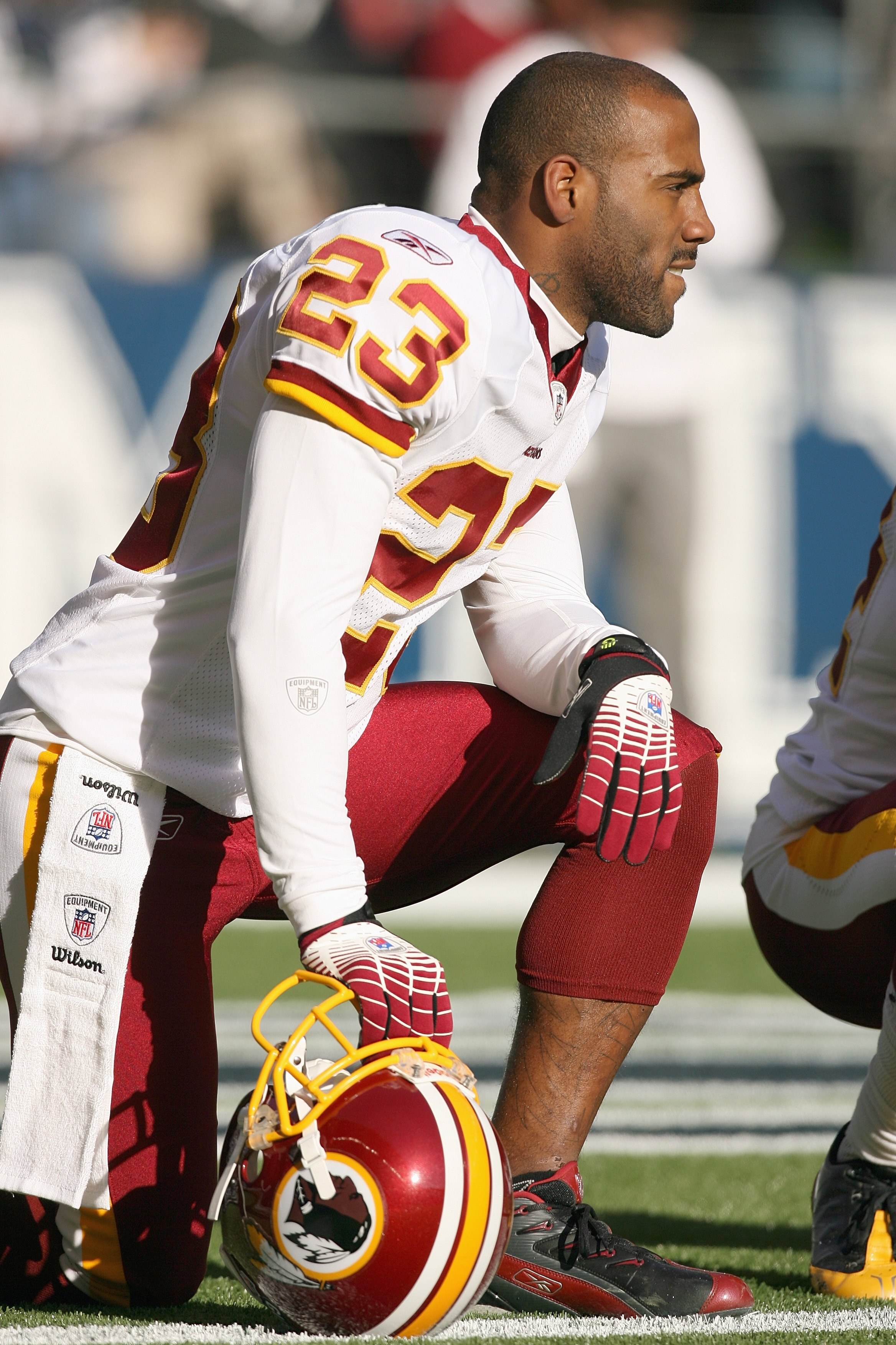 SEATTLE - NOVEMBER 23:  DeAngelo Hall #23 of the Washington Redskins kneels on the sidelines during the game against the Seattle Seahawks on November 23, 2008 at Qwest Field in Seattle, Washington. (Photo by Otto Greule Jr/Getty Images)