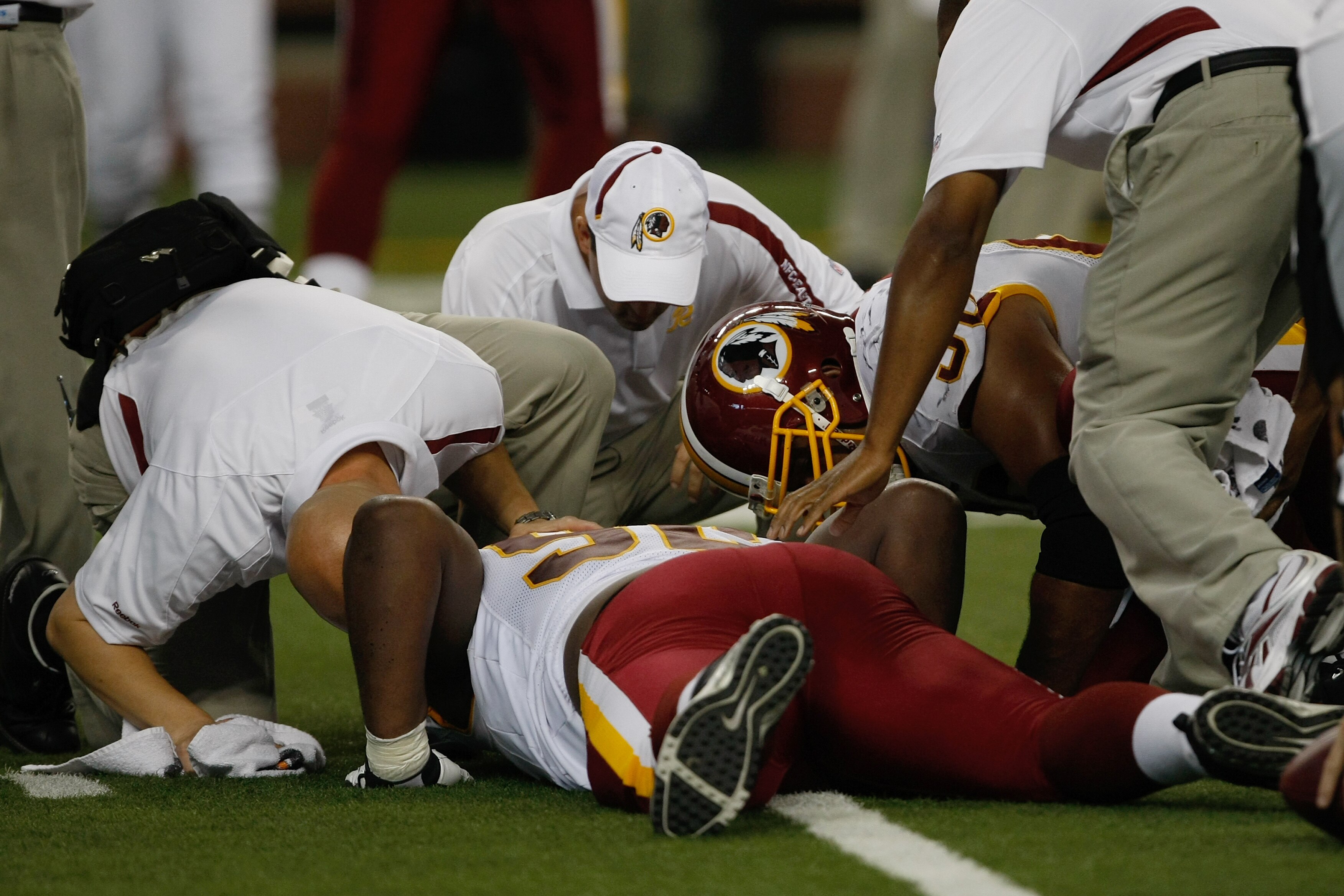 DETROIT, MI - SEPTEMBER 27: Defensive tackle Albert Haynesworth #92 of the Washington Redskins lays on the field injured as he is attended to by trainers in the first half against the Detroit Lions at Ford Field on September 27, 2009 in Detroit, Michigan.