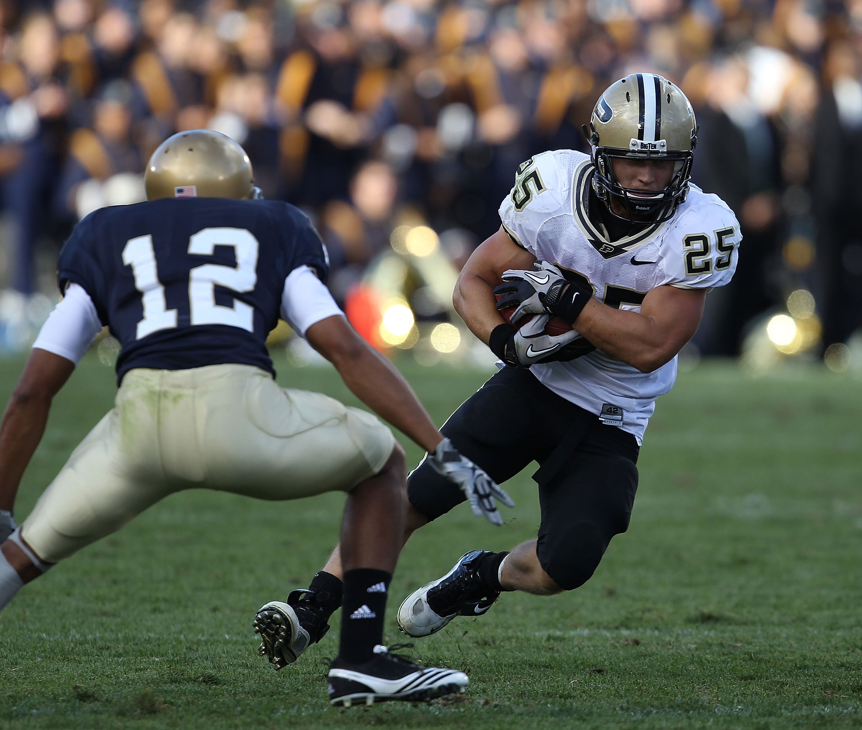 SOUTH BEND, IN - SEPTEMBER 04: Dan Dierking #25 of the Purdue Boilermakers moves against Robert Blanton #12 of the Notre Dame Fighting Irish at Notre Dame Stadium on September 4, 2010 in South Bend, Indiana. Notre Dame defated Purdue 23-12.  (Photo by Jon