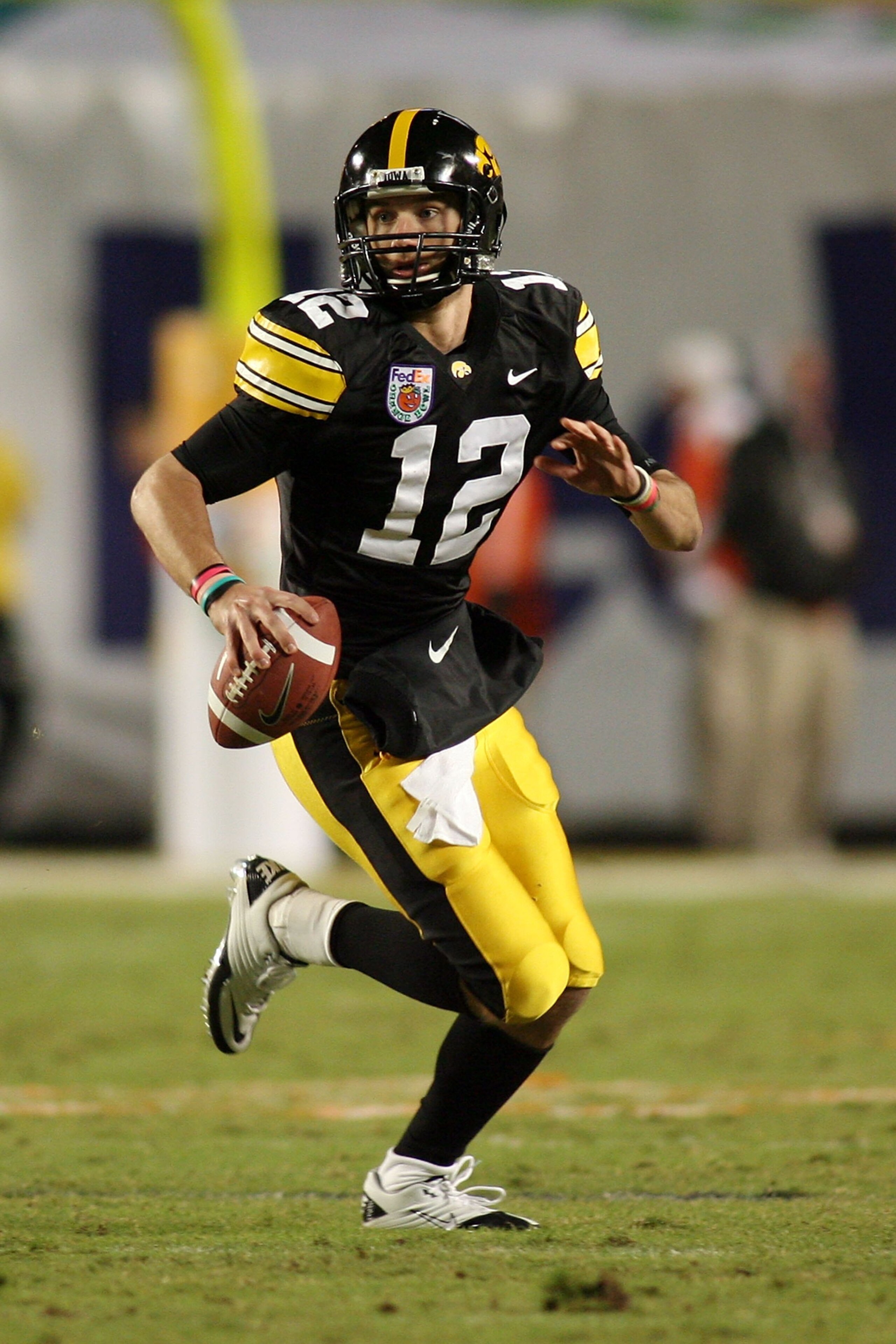 MIAMI GARDENS, FL - JANUARY 05:  Quarterback Richy Stanzi #12 of the Iowa Hawkeyes rolls out of the pocket against the Georgia Tech Yellow Jackets during the FedEx Orange Bowl at Land Shark Stadium on January 5, 2010 in Miami Gardens, Florida. Iowa won 24