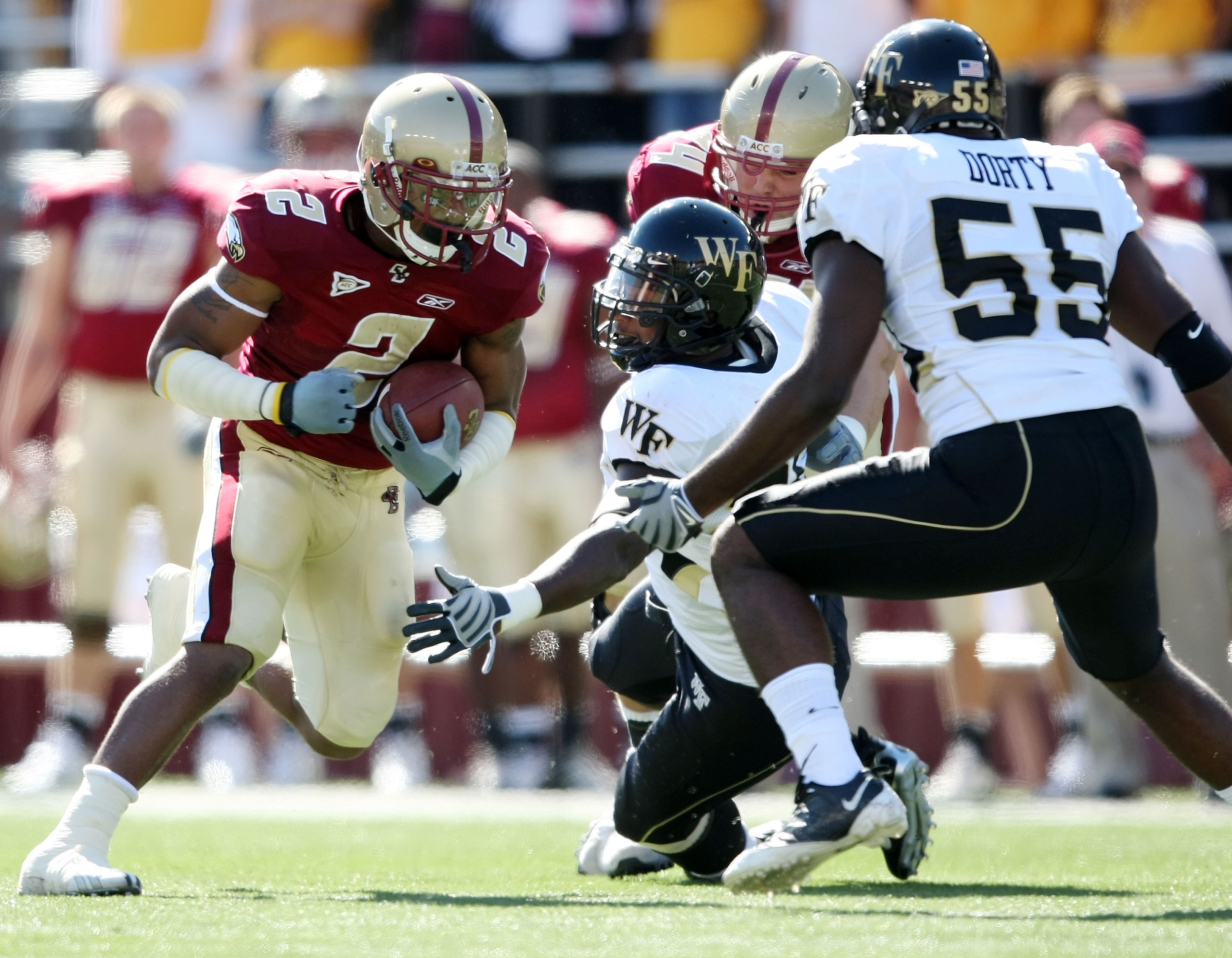 CHESTNUT HILL, MA - SEPTEMBER 26:  Montel Harris #2 of the Boston College Eagles carries the ball as Tristan Dorty #55 and Jonathan Jones #26 of the Wake Forest Demon Deacons try to make the tackle on September 26, 2009 at Alumni Stadium in Chestnut Hill,