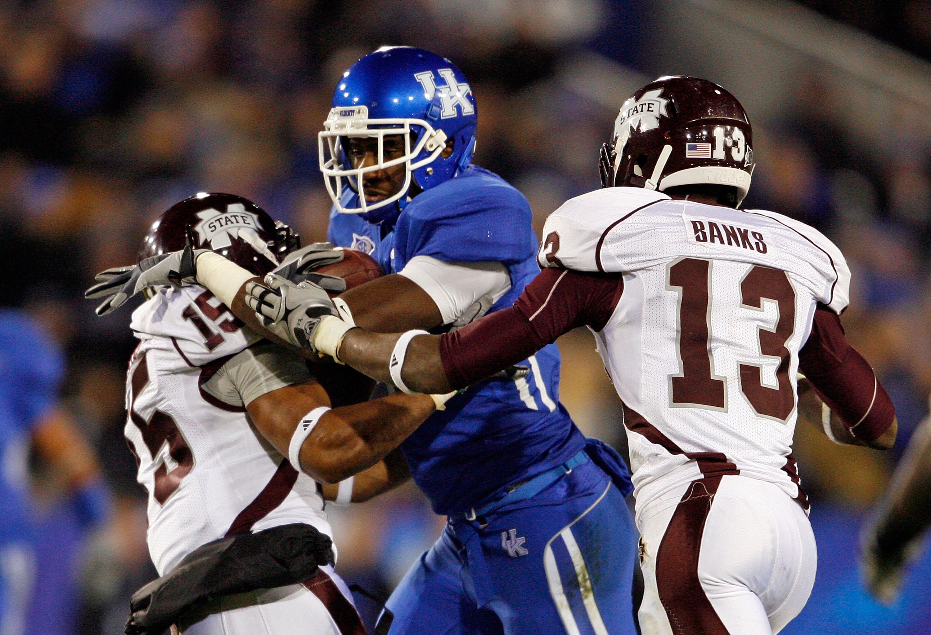 LEXINGTON, KY - OCTOBER 31:  Maurice Langston #15 and Johnthan Banks #13 of the Mississippi State Bulldogs tackles Chris Matthews #8 of the Kentucky Wildcats during the SEC game at Commonwealth Stadium on October 31, 2009 in Lexington, Kentucky.  (Photo b