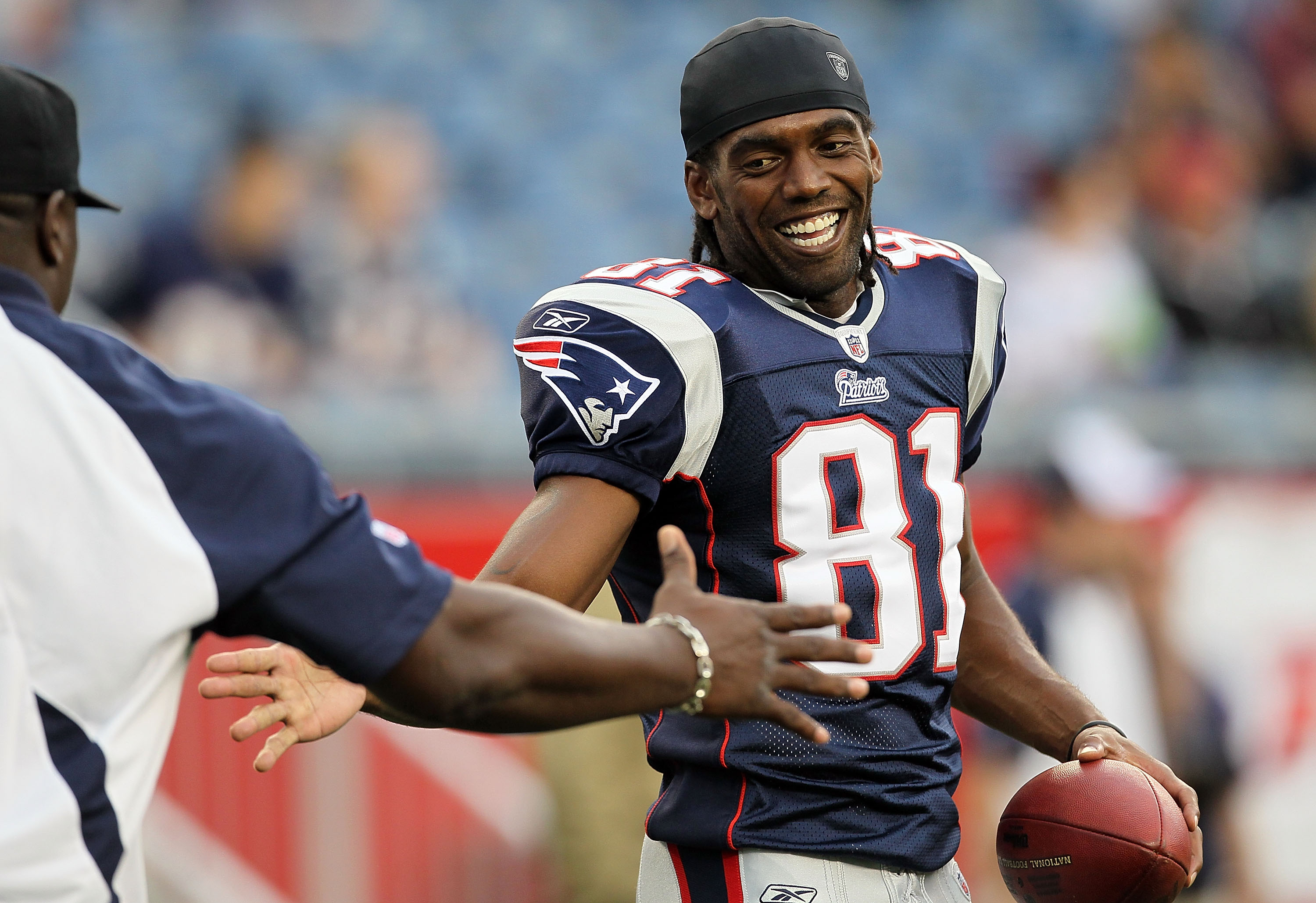 FOXBORO, MA - AUGUST 12: Randy Moss #81 of the New England Patriots smiles before the preseason game against the New Orleans Saints at Gillette Stadium on August 12, 2010 in Foxboro, Massachusetts. (Photo by Jim Rogash/Getty Images)