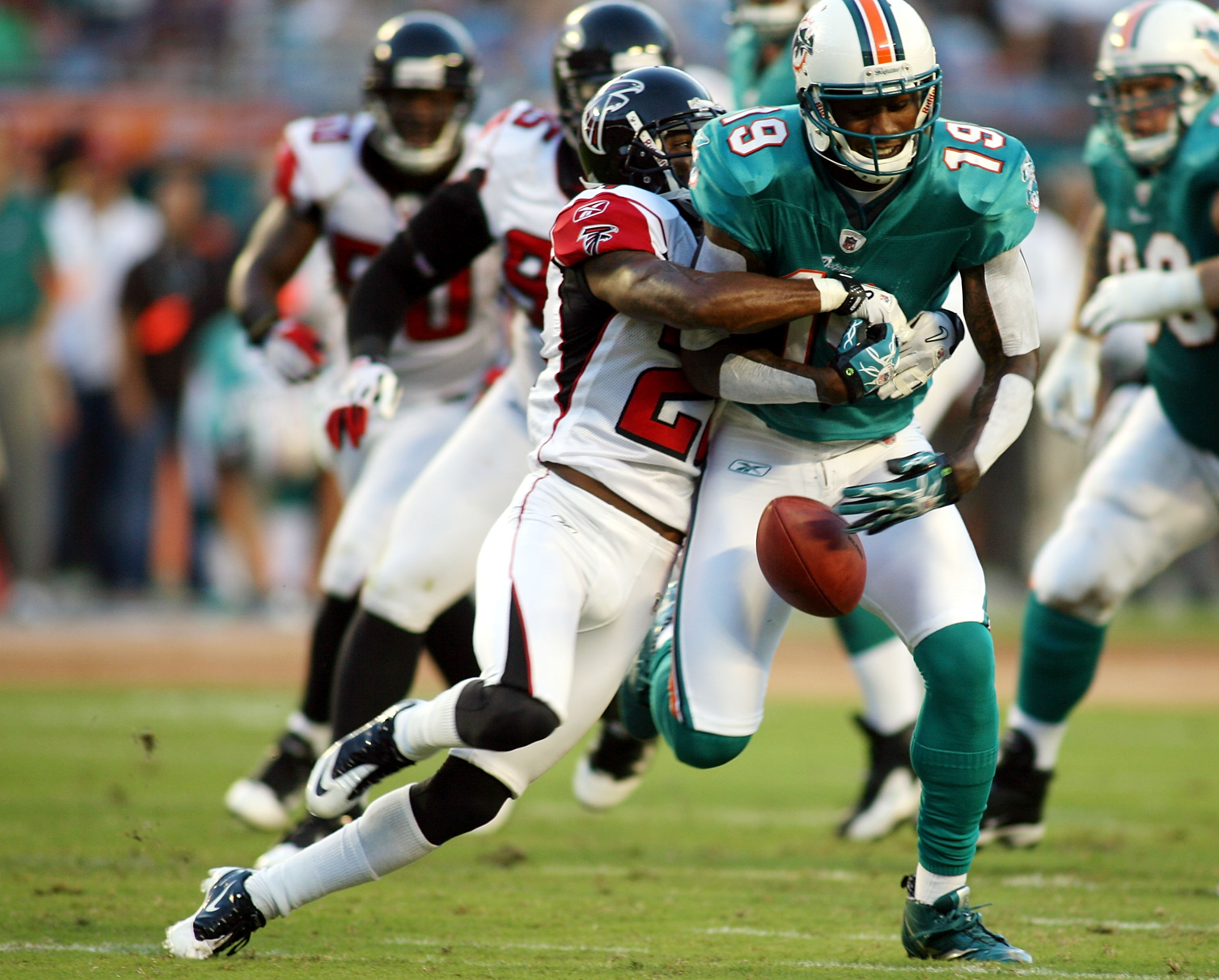 MIAMI - AUGUST 27:  Wide reciever Brandon Marshall #19 of the Miami Dolphins drops the ball  against cornerback Brent Grimes #20 of the Atlanta Falcons during their preseason game at Sun Life Stadium on August 27, 2010 in Miami, Florida.  (Photo by Marc S