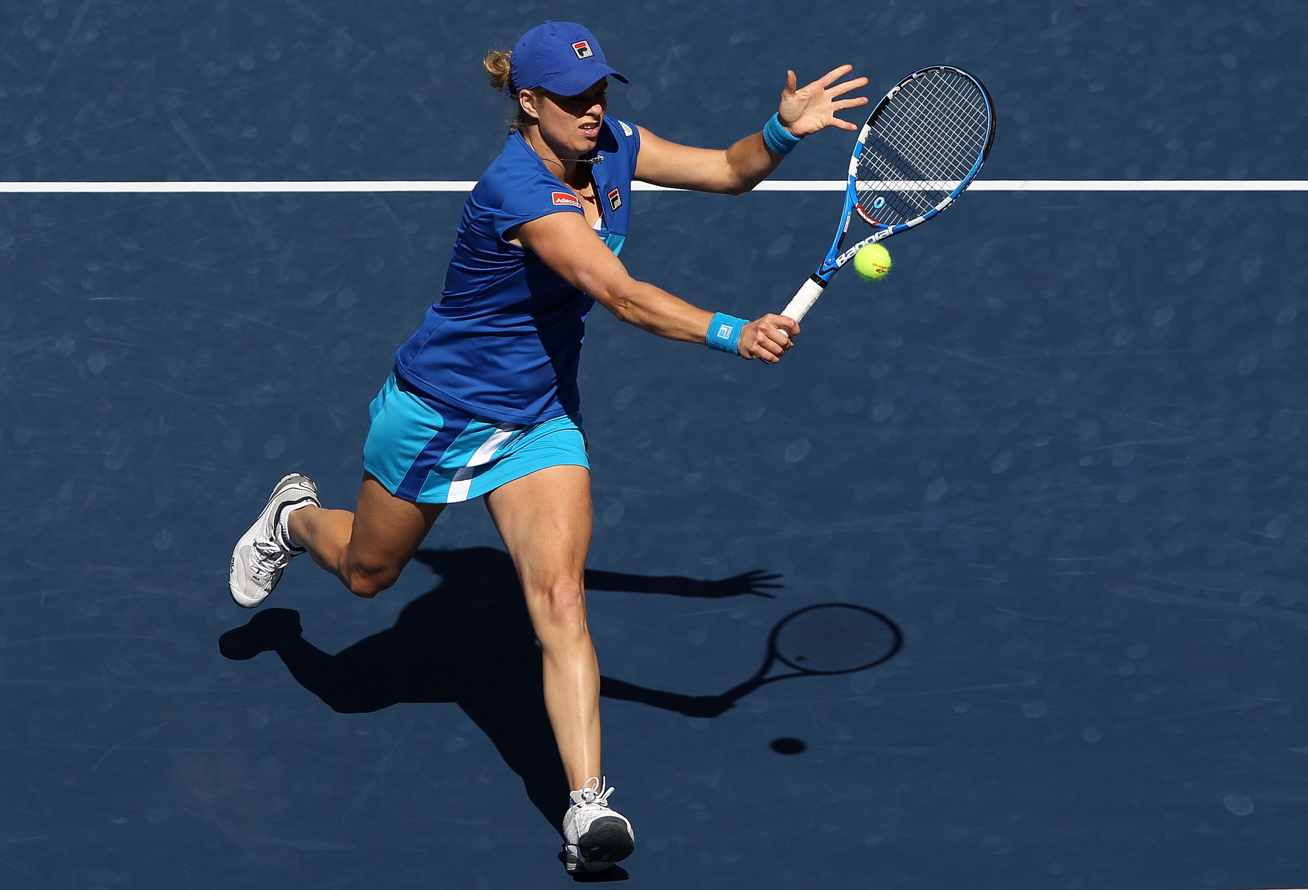 NEW YORK - SEPTEMBER 05: Kim Clijsters of Belgium returns a shot against Ana Ivanovic of Serbia during her women's singles match on day seven of the 2010 U.S. Open at the USTA Billie Jean King National Tennis Center on September 5, 2010 in the Flushing n NEW YORK - SEPTEMBER 05: Kim Clijsters of Belgium returns a shot against Ana Ivanovic of Serbia during her women's singles match on day seven of the 2010 U.S. Open at the USTA Billie Jean King National Tennis Center on September 5, 2010 in the Flushing n