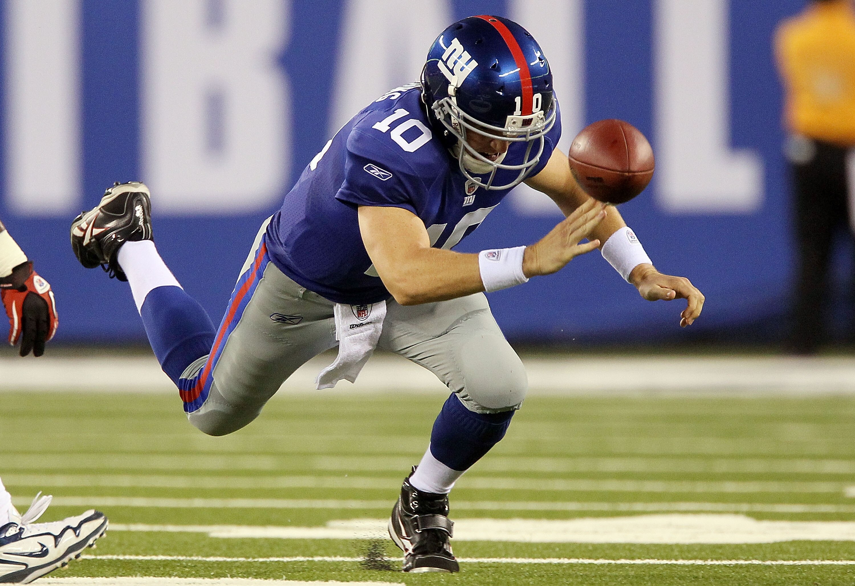 EAST RUTHERFORD, NJ - SEPTEMBER 02:  Eli Manning #10 of the New York Giants fumbles the ball in the first quarter against the New England Patriots on September 2, 2010 at the New Meadowlands Stadium in East Rutherford, New Jersey.  (Photo by Jim McIsaac/G