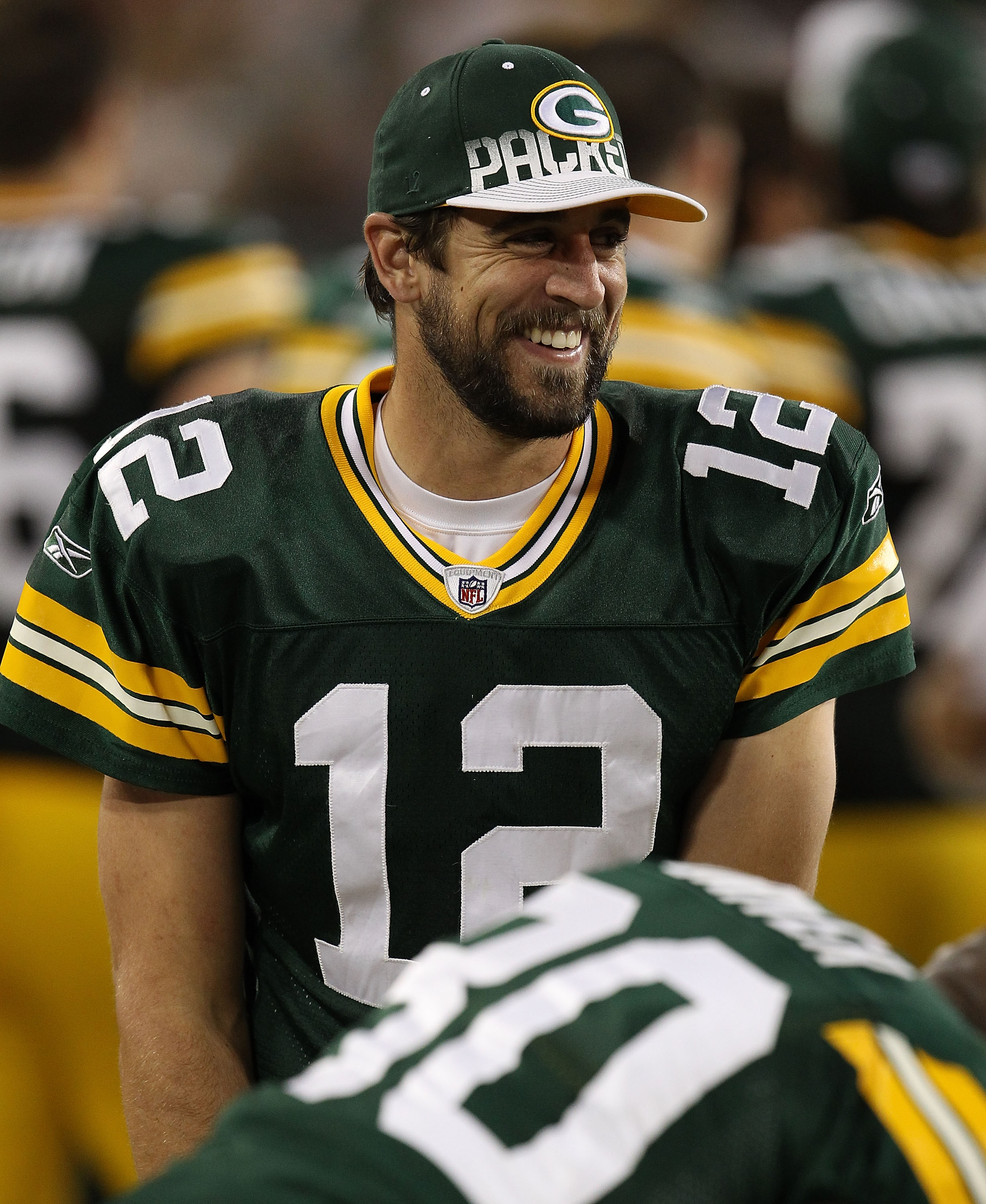 GREEN BAY, WI - AUGUST 26: Aaron Rodgers #12 of the Green Bay Packers jokes with teammate Donald Driver #80 on the sidelines during a game against the Indianapolis Colts at Lambeau Field on August 26, 2010 in Green Bay, Wisconsin. The Packer defeated the