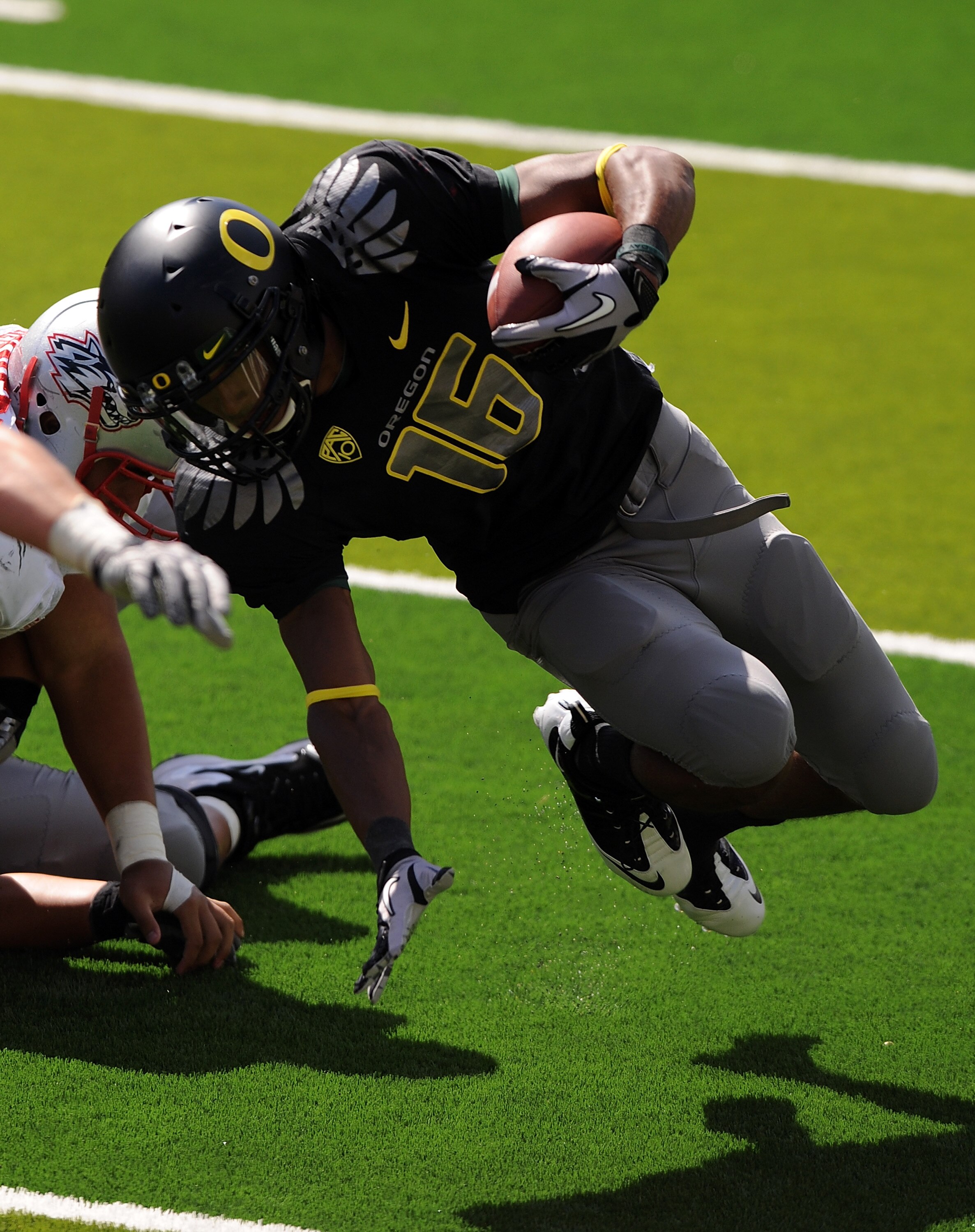 EUGENE, OR - SEPTEMBER 04: Quarterback Daryle Hawkins #16 of the Oregon Ducks is tripped up after a short gain in the third quarter of the game against the New Mexico Lobos at Autzen Stadium on September 4, 2010 in Eugene, Oregon. Oregon won the game 72-0