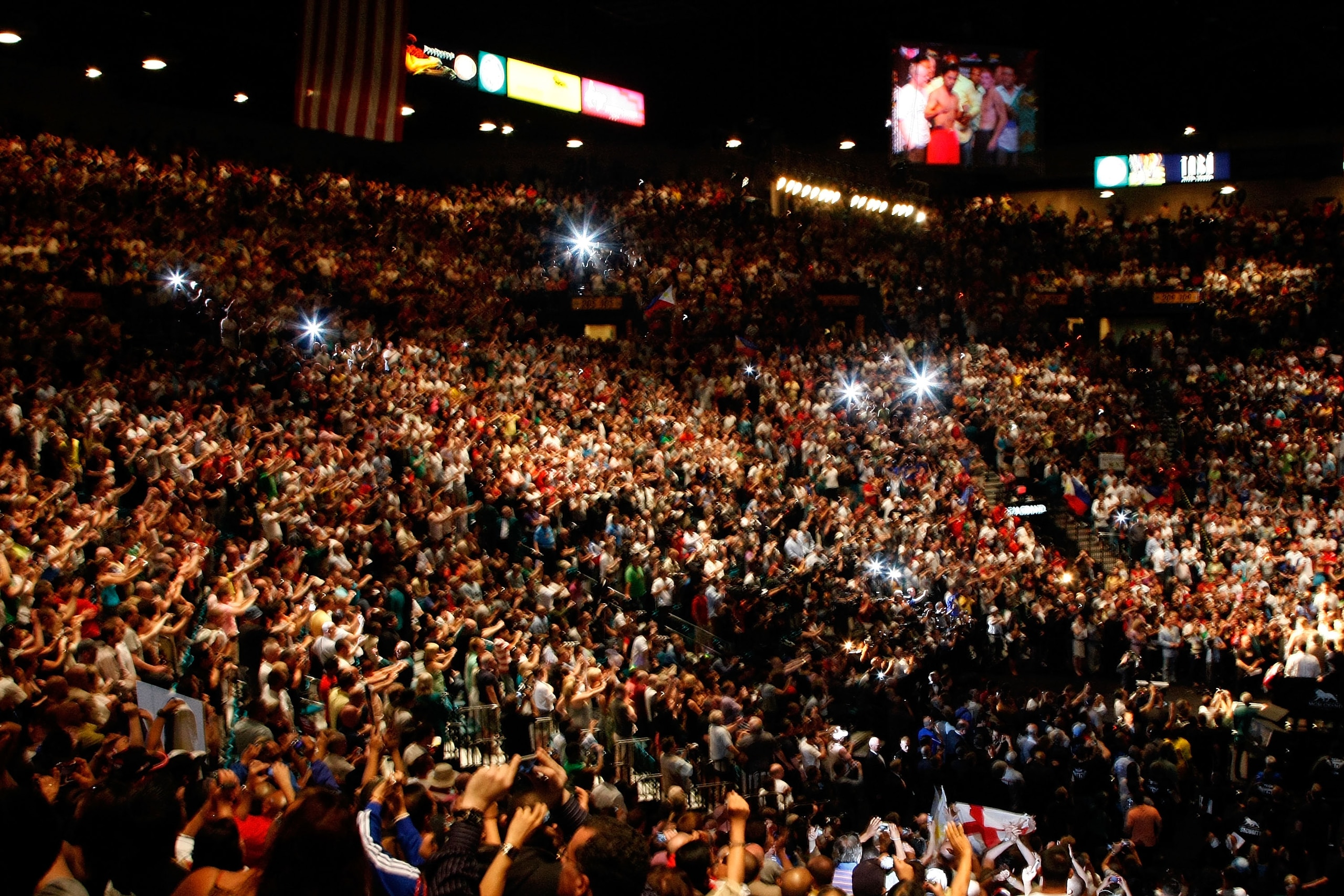 LAS VEGAS - MAY 01:  Fans take pictures as Manny Pacquiao of the Philippines and Ricky Hatton of England pose after both fighters stepped on the scale during the weigh-in for their junior welterweight title fight at the MGM Grand Garden Arena May 1, 2009