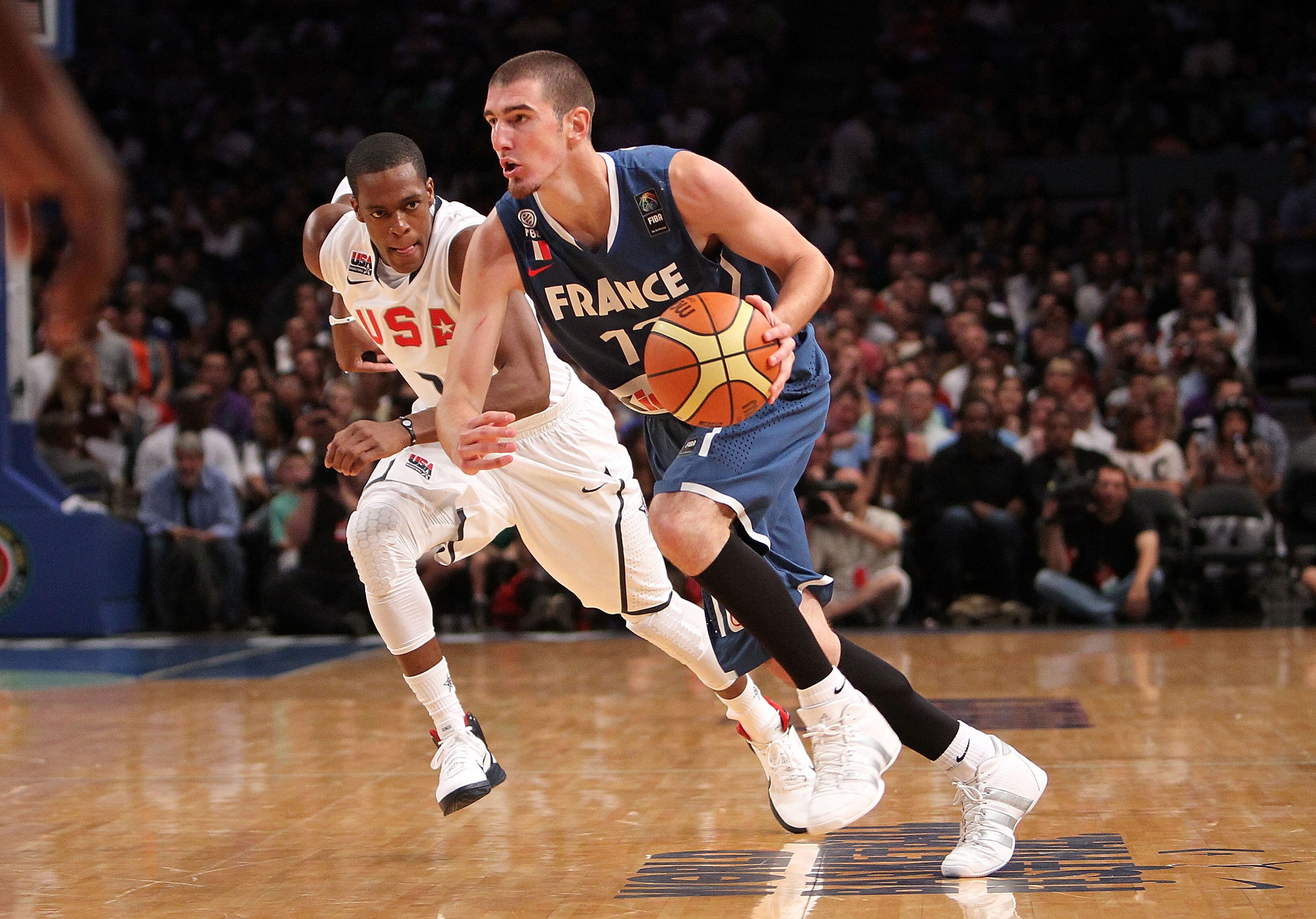 NEW YORK - AUGUST 15:  Nando De Colo #12 of France dribbles past Rajon Rondo #7 of the United States during their exhibition game as part of the World Basketball Festival at Madison Square Garden on August 15, 2010 in New York City.  (Photo by Nick Laham/