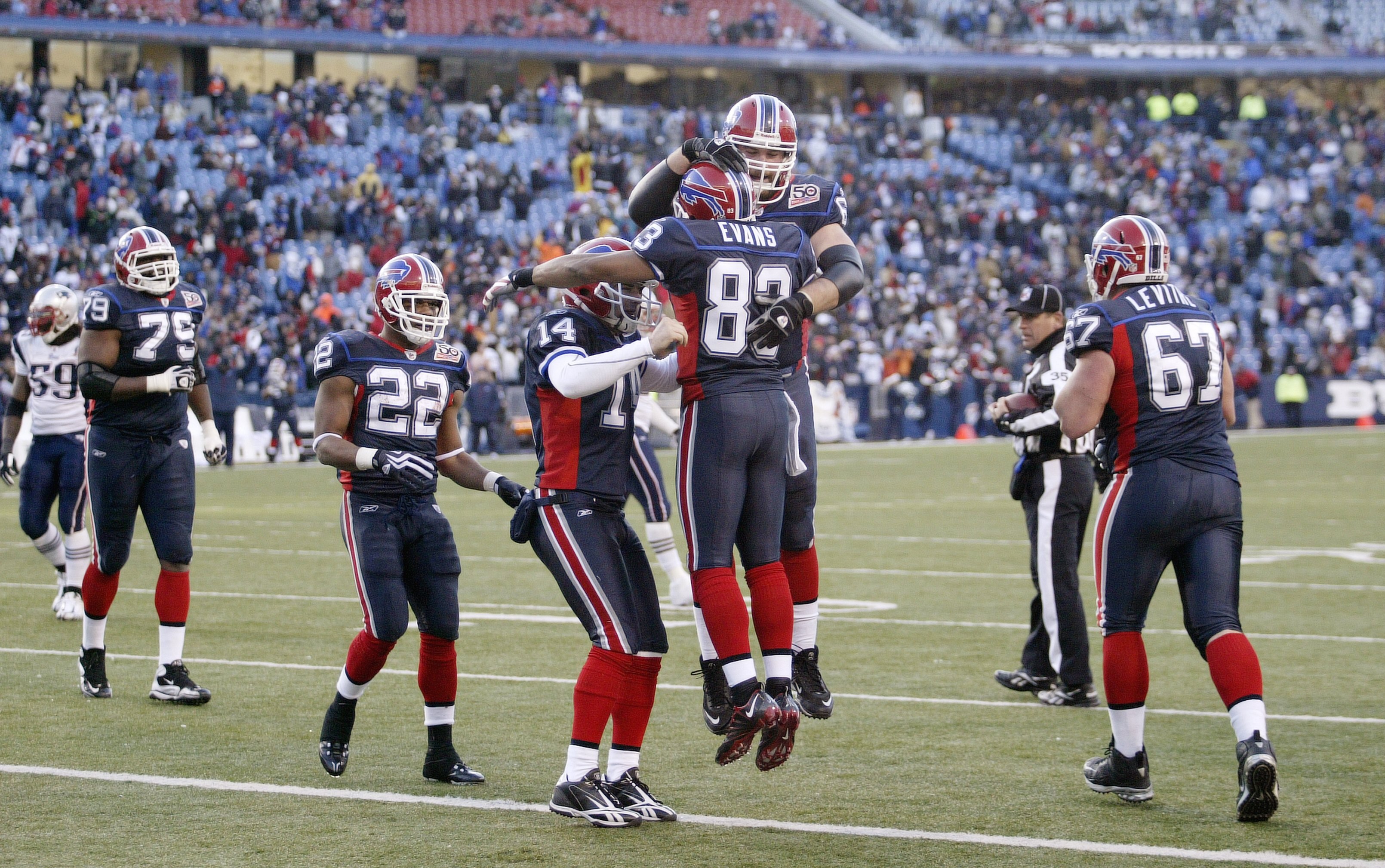 ORCHARD PARK, NY - DECEMBER 20: Geoff Hangartner #63, Lee Evans #83 and Ryan Fitzpatrick #14 of the Buffalo Bills celebrate against the New England Patriots during the game at Ralph Wilson Stadium on December 20, 2009 in Orchard Park, New York. (Photo by:
