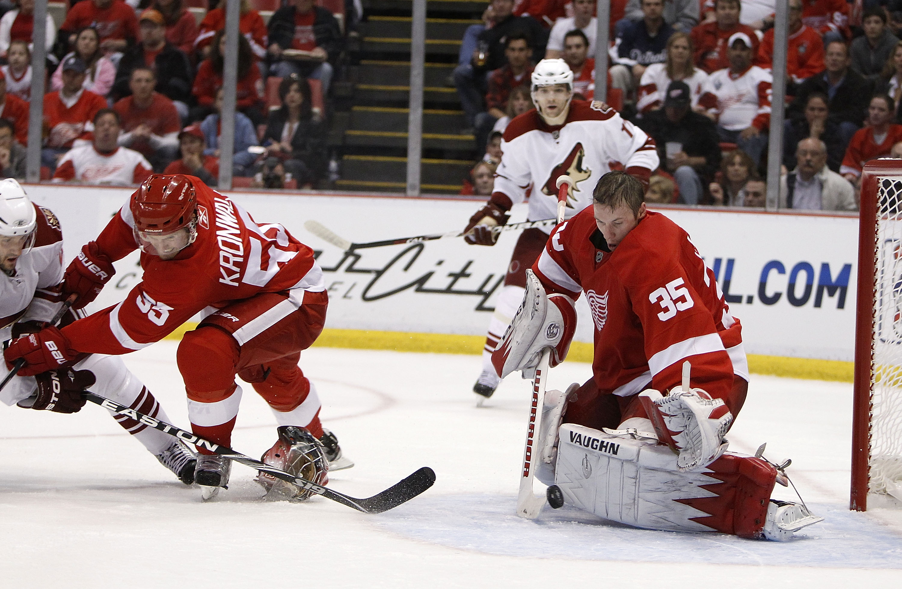 DETROIT - APRIL 20: Jimmy Howard #35 of the Detroit Red Wings makes a save without his goalie mask behind teammate Niklas Kronwall #55 and Lee Stempniak #22 of the Phoenix Coyotes during Game Four of the Western Conference Quarterfinals of the 2010 NHL S DETROIT - APRIL 20: Jimmy Howard #35 of the Detroit Red Wings makes a save without his goalie mask behind teammate Niklas Kronwall #55 and Lee Stempniak #22 of the Phoenix Coyotes during Game Four of the Western Conference Quarterfinals of the 2010 NHL S