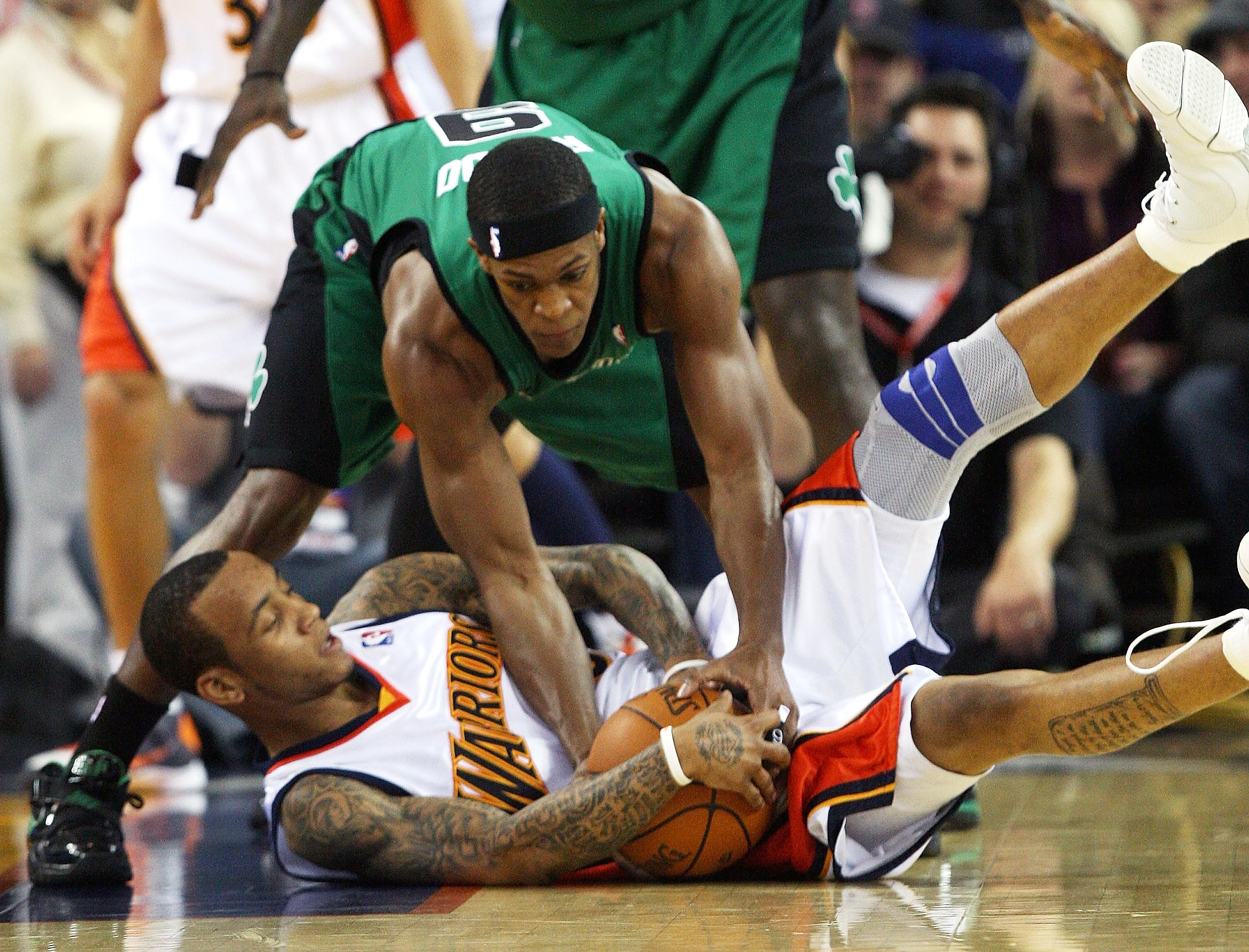 OAKLAND, CA - DECEMBER 28:  Rajon Rondo #9 of the Boston Celtics  fights for the ball with Monta Ellis #8 of the Golden State Warriors during an NBA game at Oracle Arena on December 28, 2009 in Oakland, California. NOTE TO USER: User expressly acknowledge