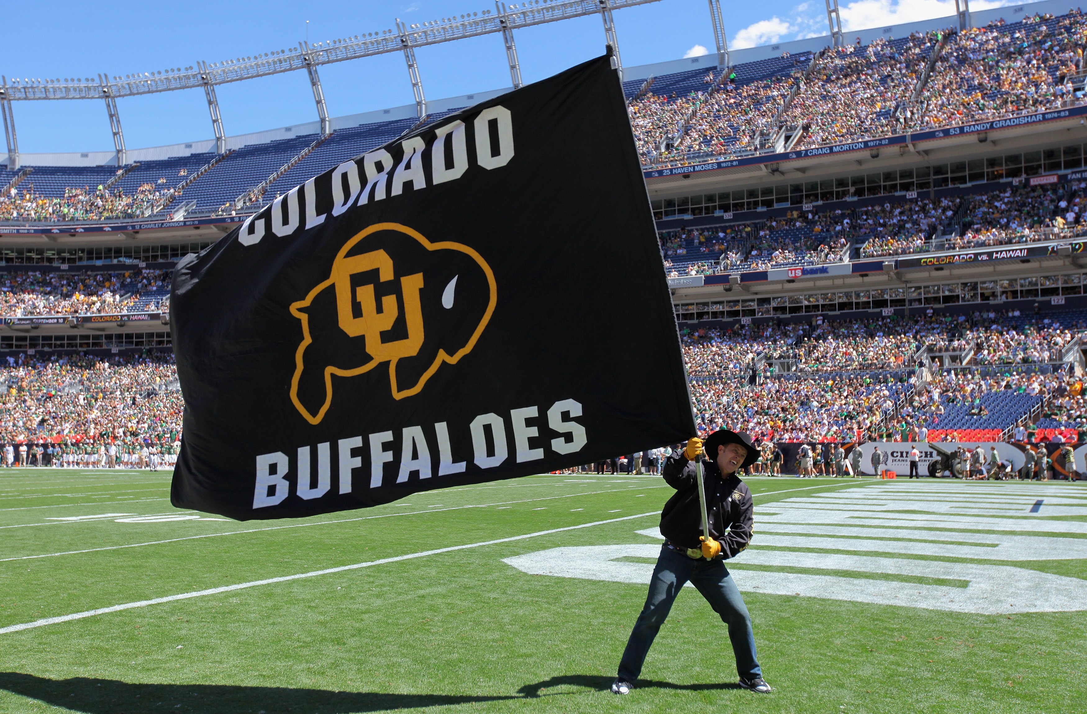 DENVER - SEPTEMBER 04:  A supporter of the Colorado Buffaloes waives a flag in the endzone against the Colorado State Rams in the Rocky Mountain Showdown at INVESCO Field at Mile High on September 4, 2010 in Denver, Colorado.  (Photo by Doug Pensinger/Get