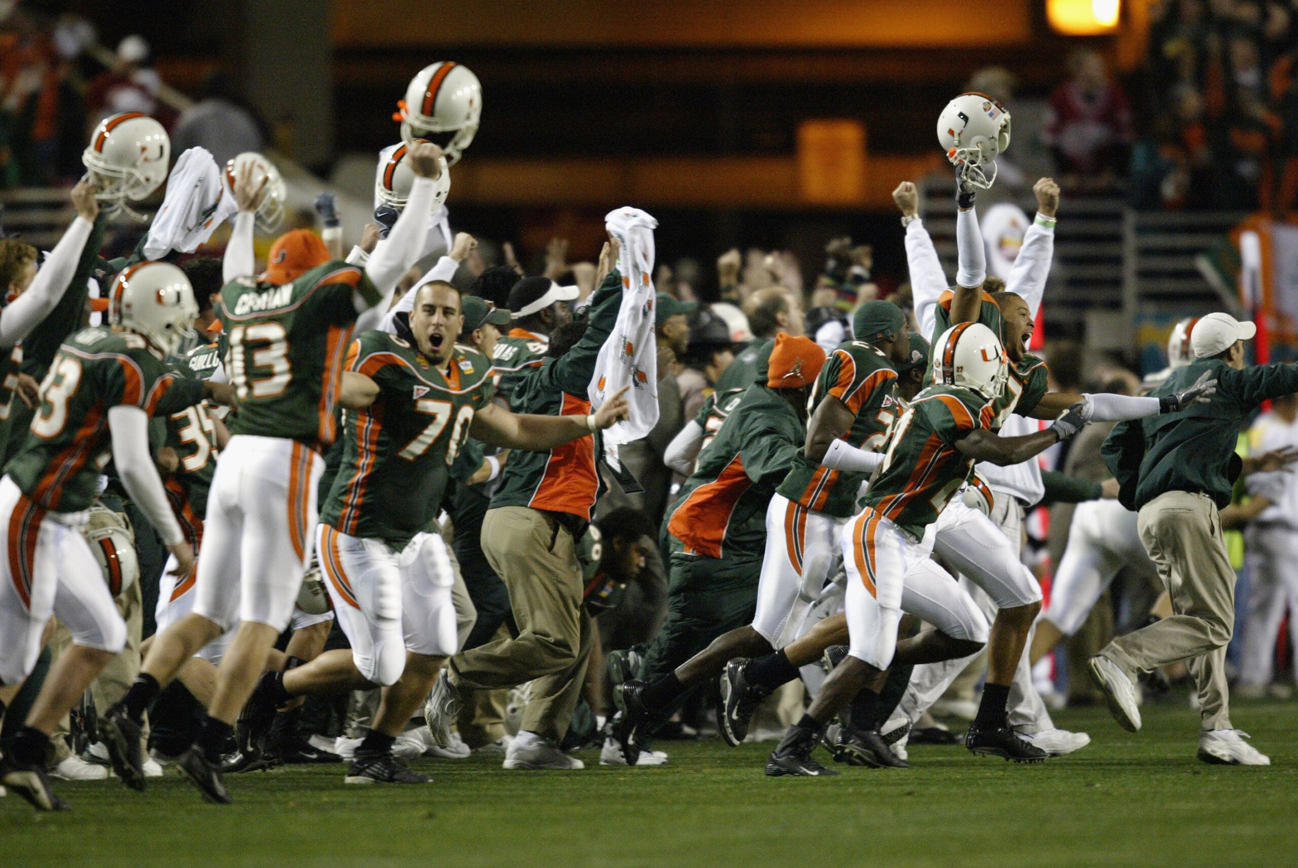 TEMPE, AZ - JANUARY 3:  Before seeing the flag thrown by an official, the Miami Hurricanes players and the coaches celebrate at the end of the first over-time against the Ohio State Buckeyes in the Tostitos Fiesta Bowl on January 3, 2003 at Sun Devil Stad